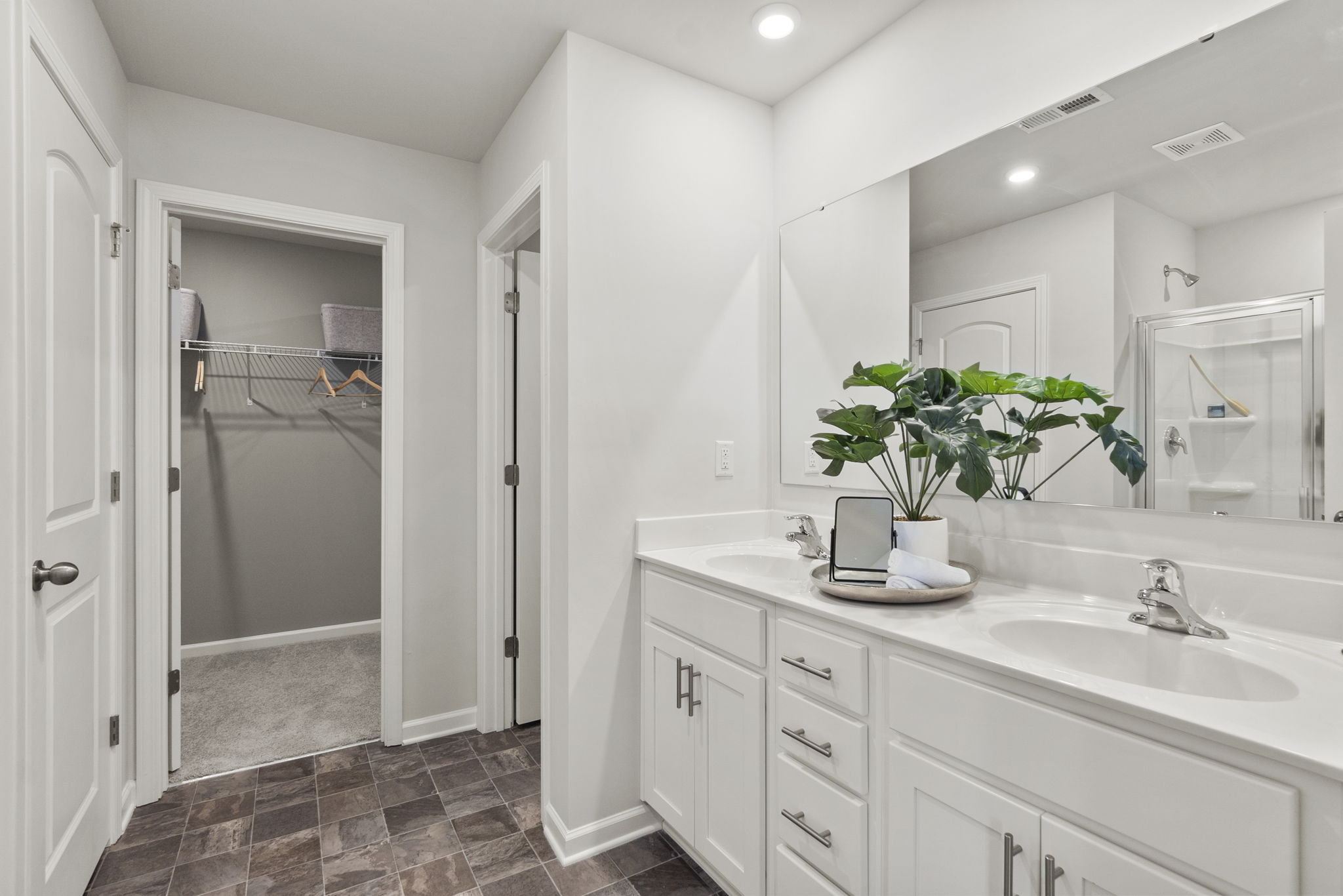 A bathroom with a sink and a shower.