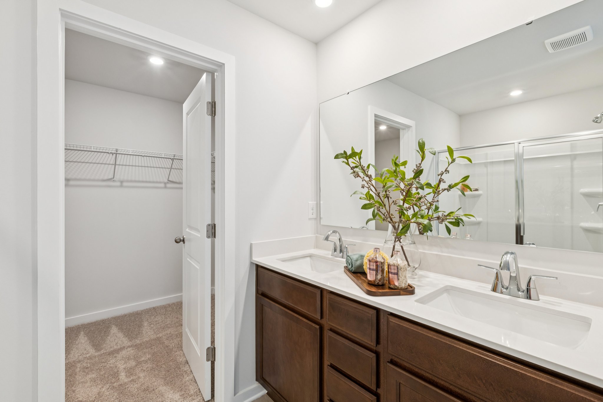 A bathroom with a large mirror.