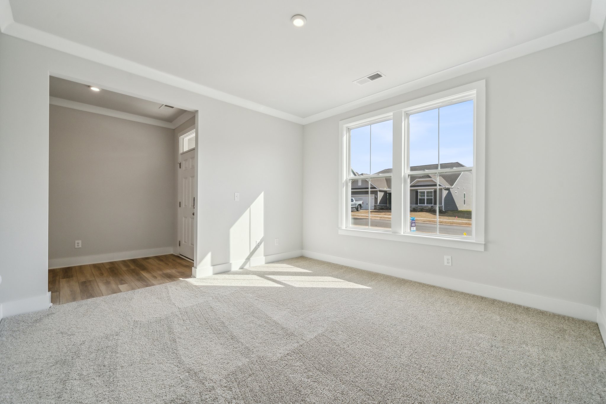 A room with a window and a door.