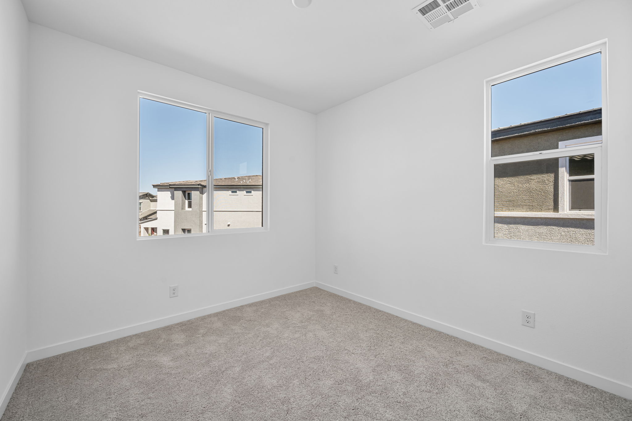 A room with a window and a carpet.