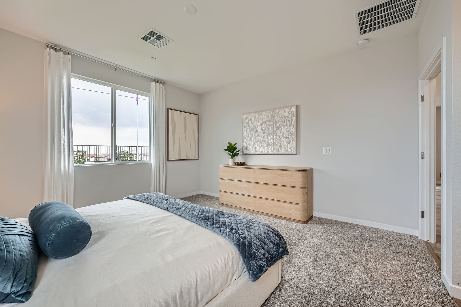 A bedroom with a bed and a dresser.