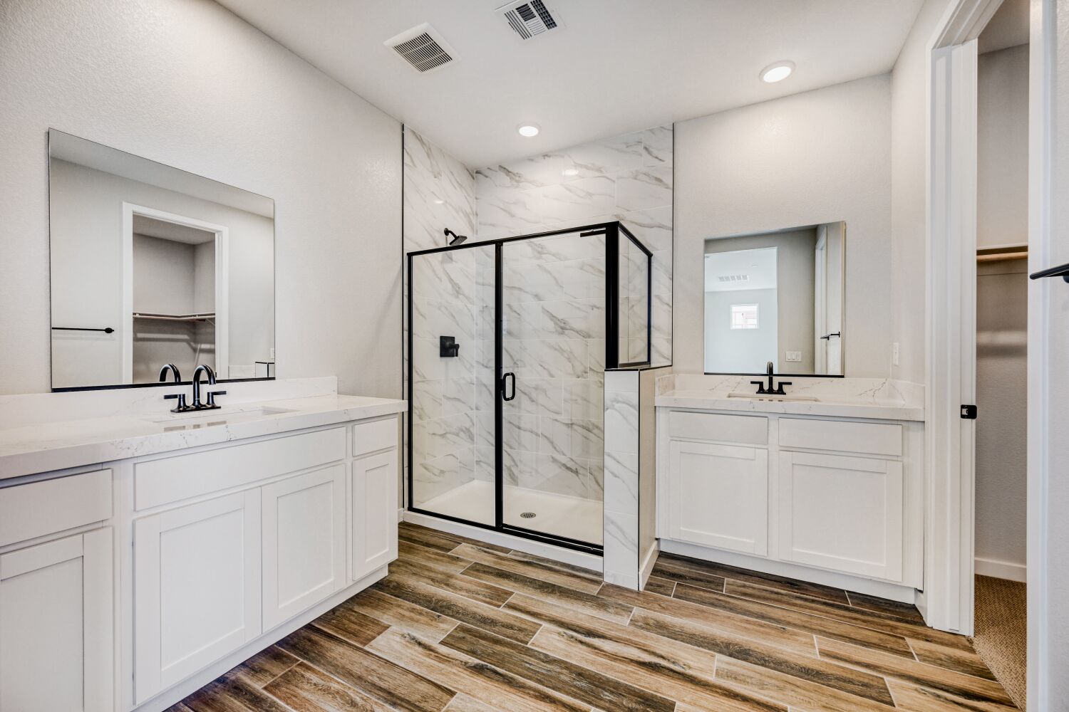 A bathroom with white cabinets.