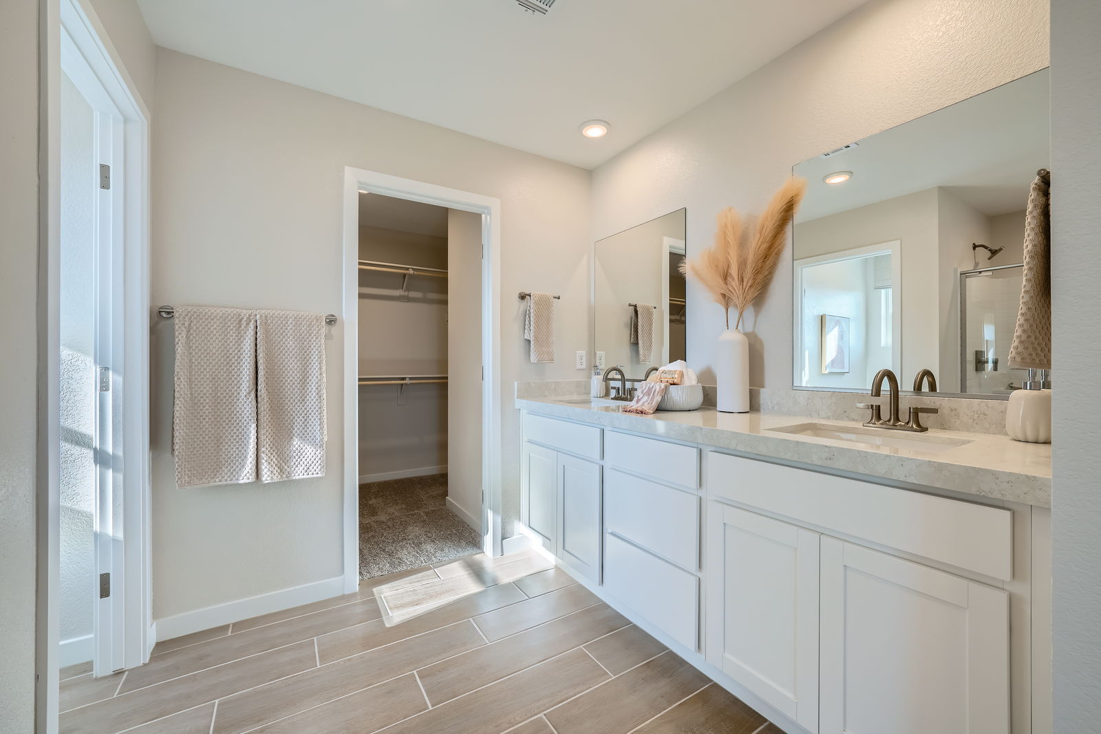 A bathroom with a large mirror.