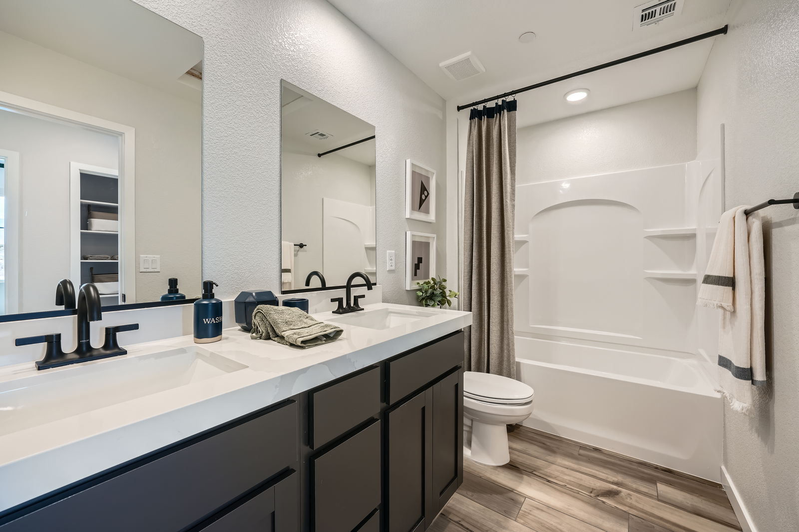 A bathroom with a tub sink and toilet.