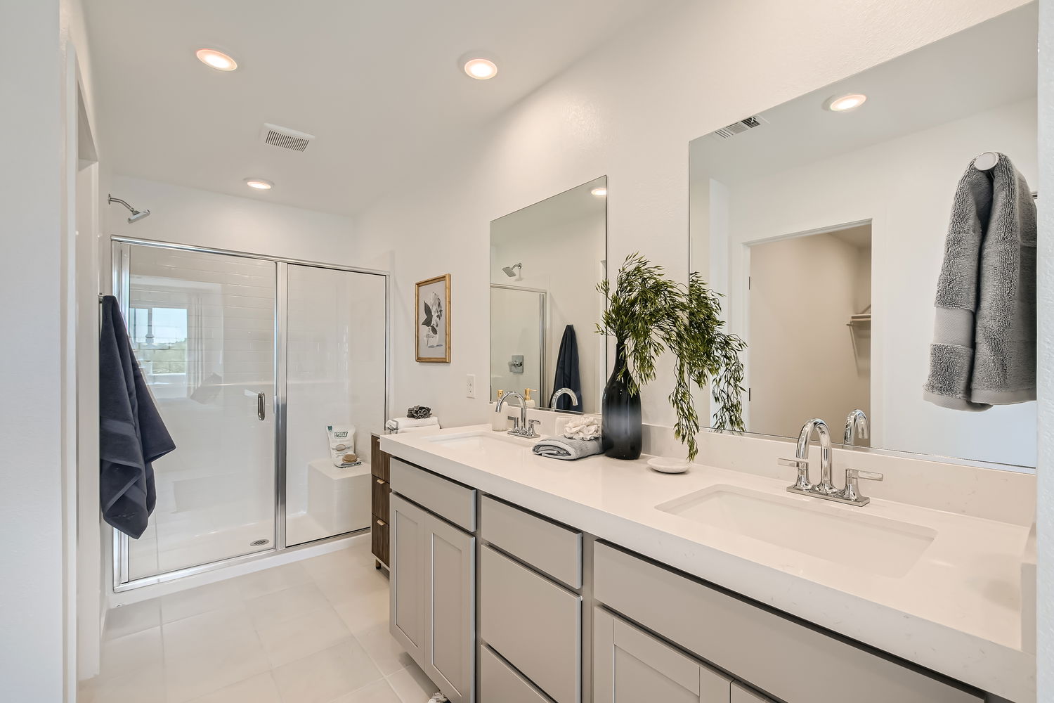A bathroom with a large mirror.