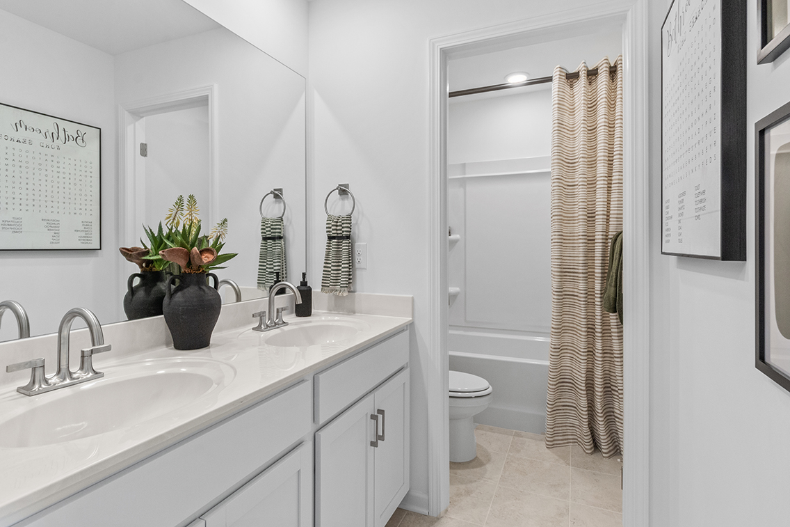 A bathroom with a shower and sink.