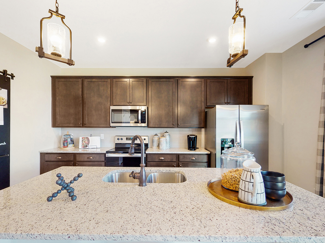 A kitchen with a marble countertop.