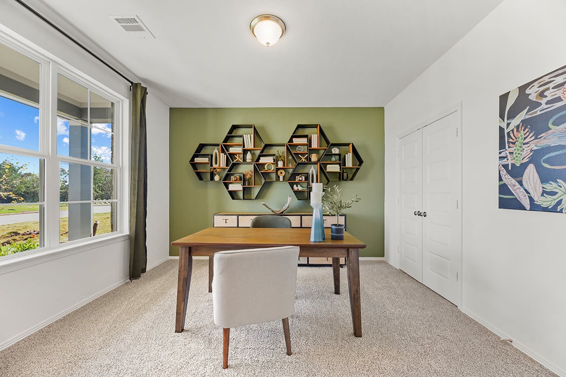 A room with a table and chairs.