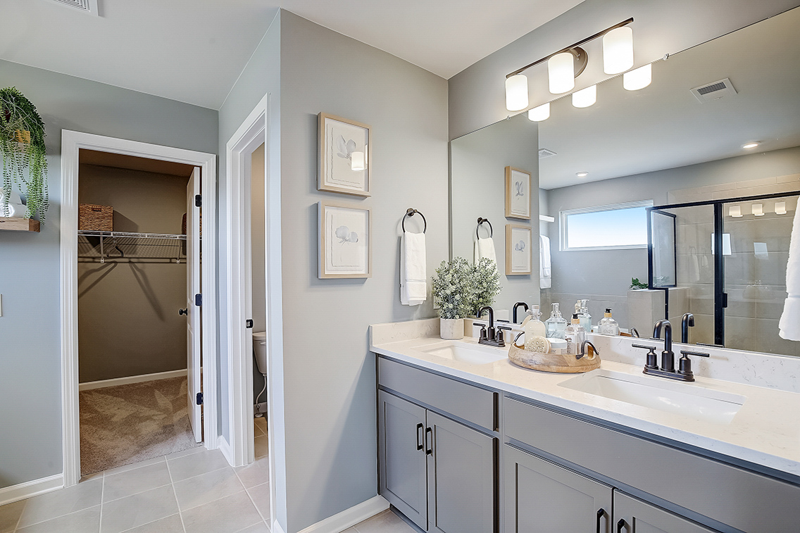 A bathroom with a large mirror.