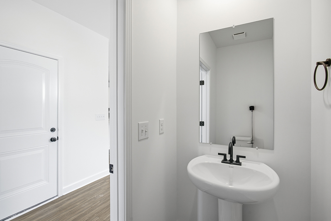 A bathroom with a sink and mirror.