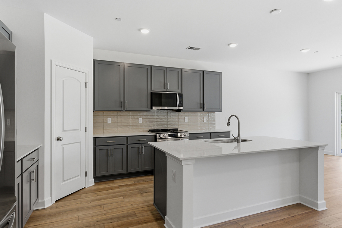 A kitchen with black cabinets.