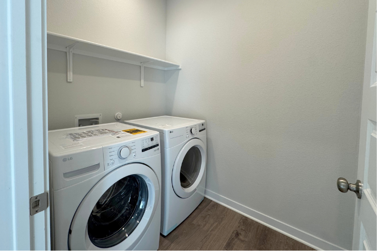 A washing machine and dryer in a room.