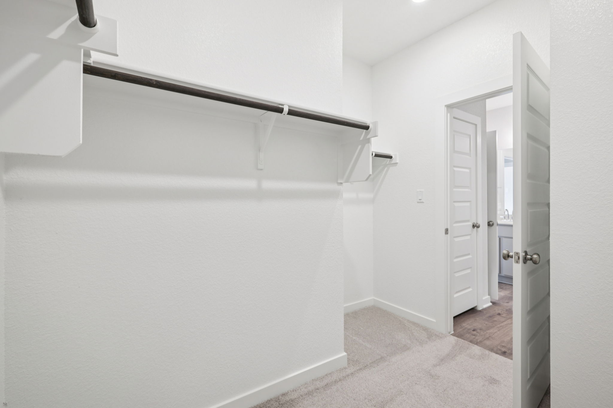 A hallway with white walls.