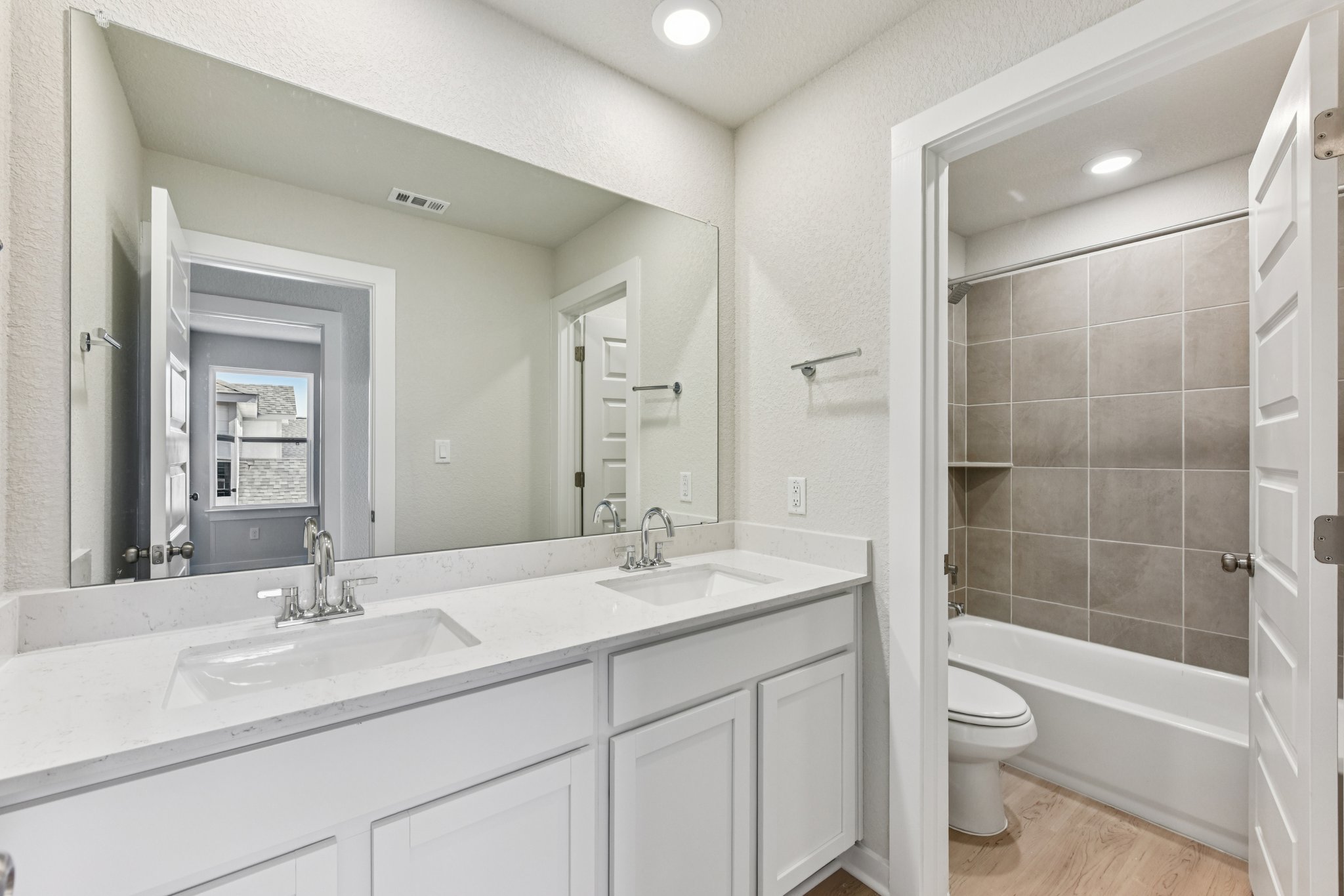 A bathroom with a tub sink and toilet.