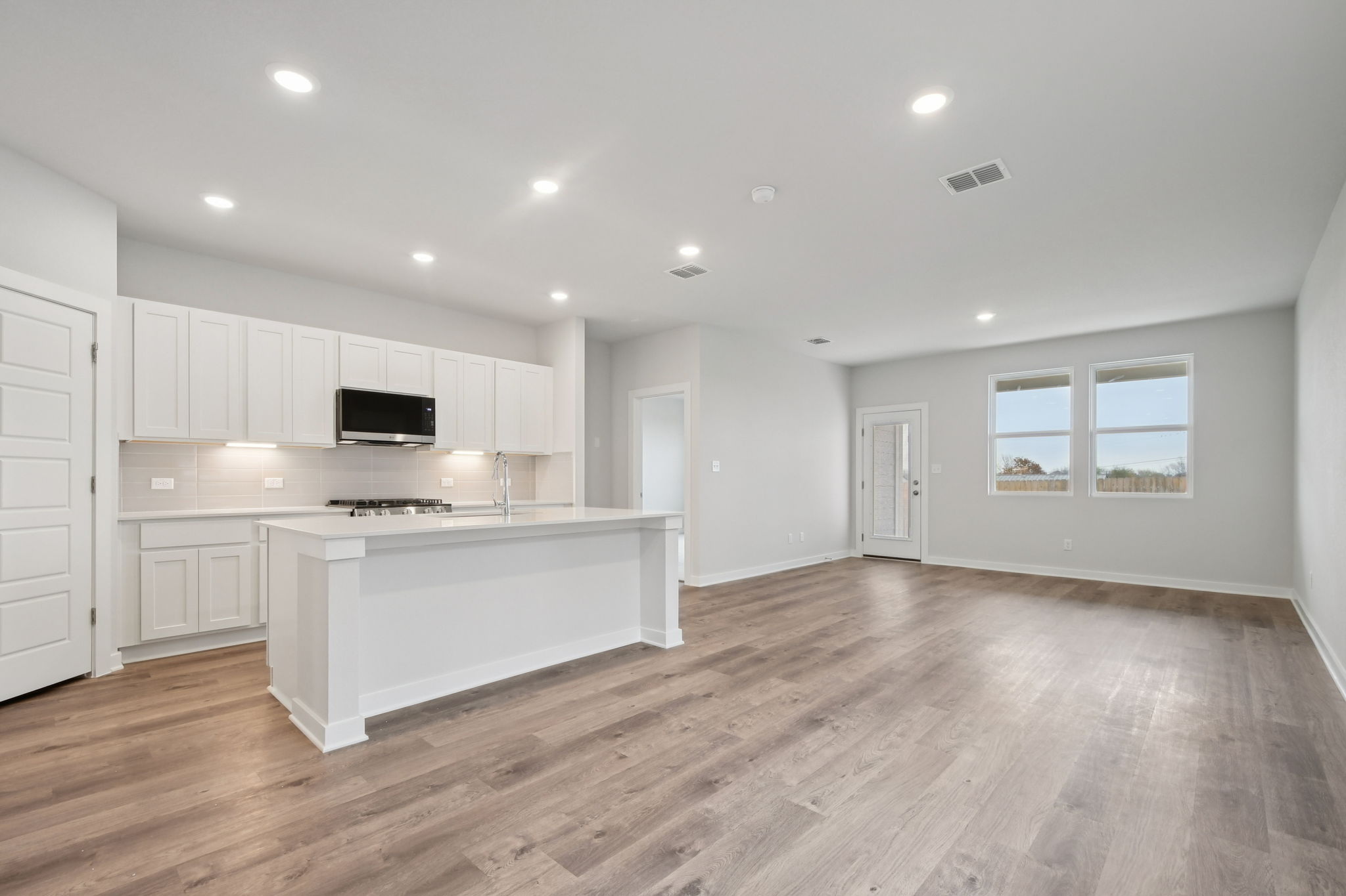 A large kitchen with white cabinets.