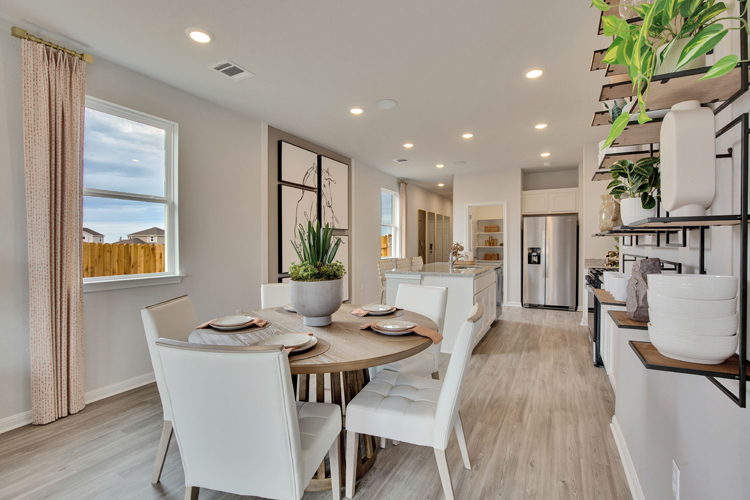 A dining room with a table and chairs.