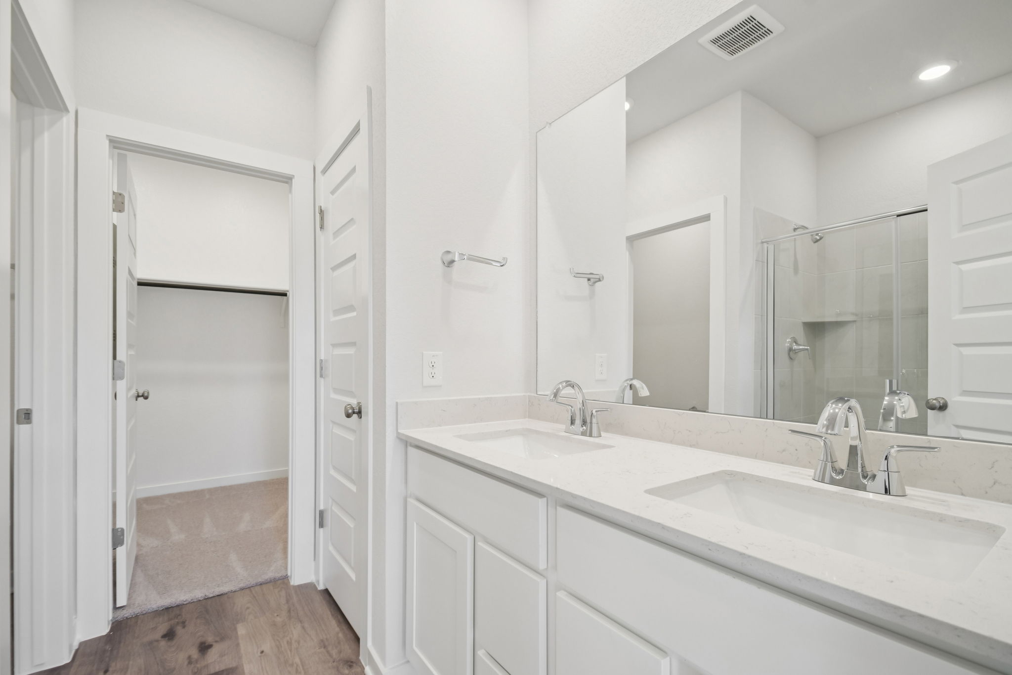 A bathroom with a large mirror.