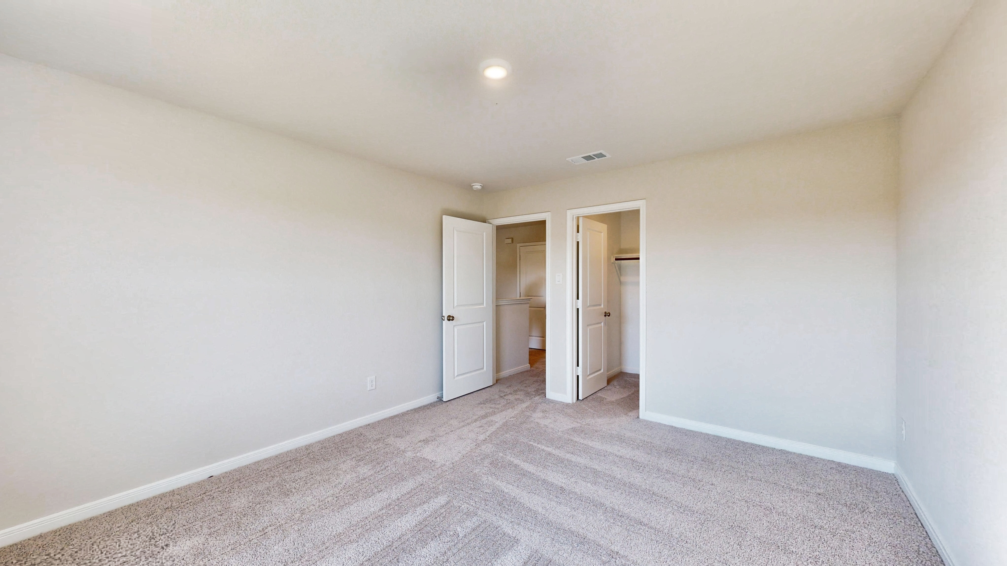 A hallway with white walls.