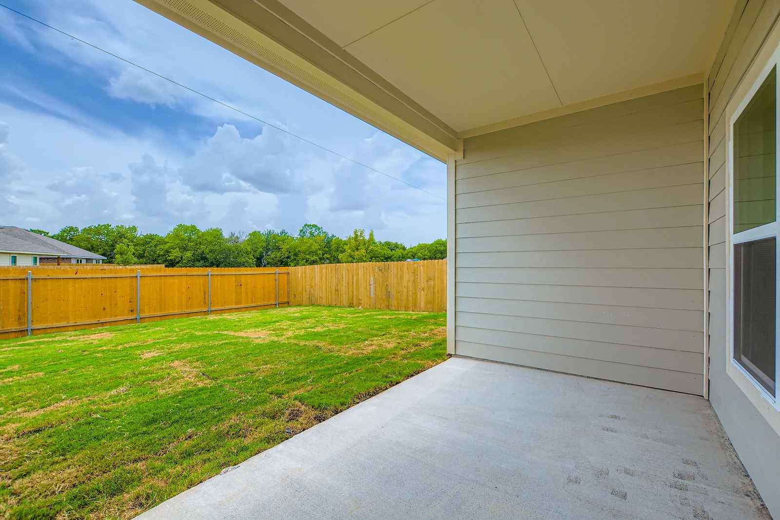 A house with a fence and grass.