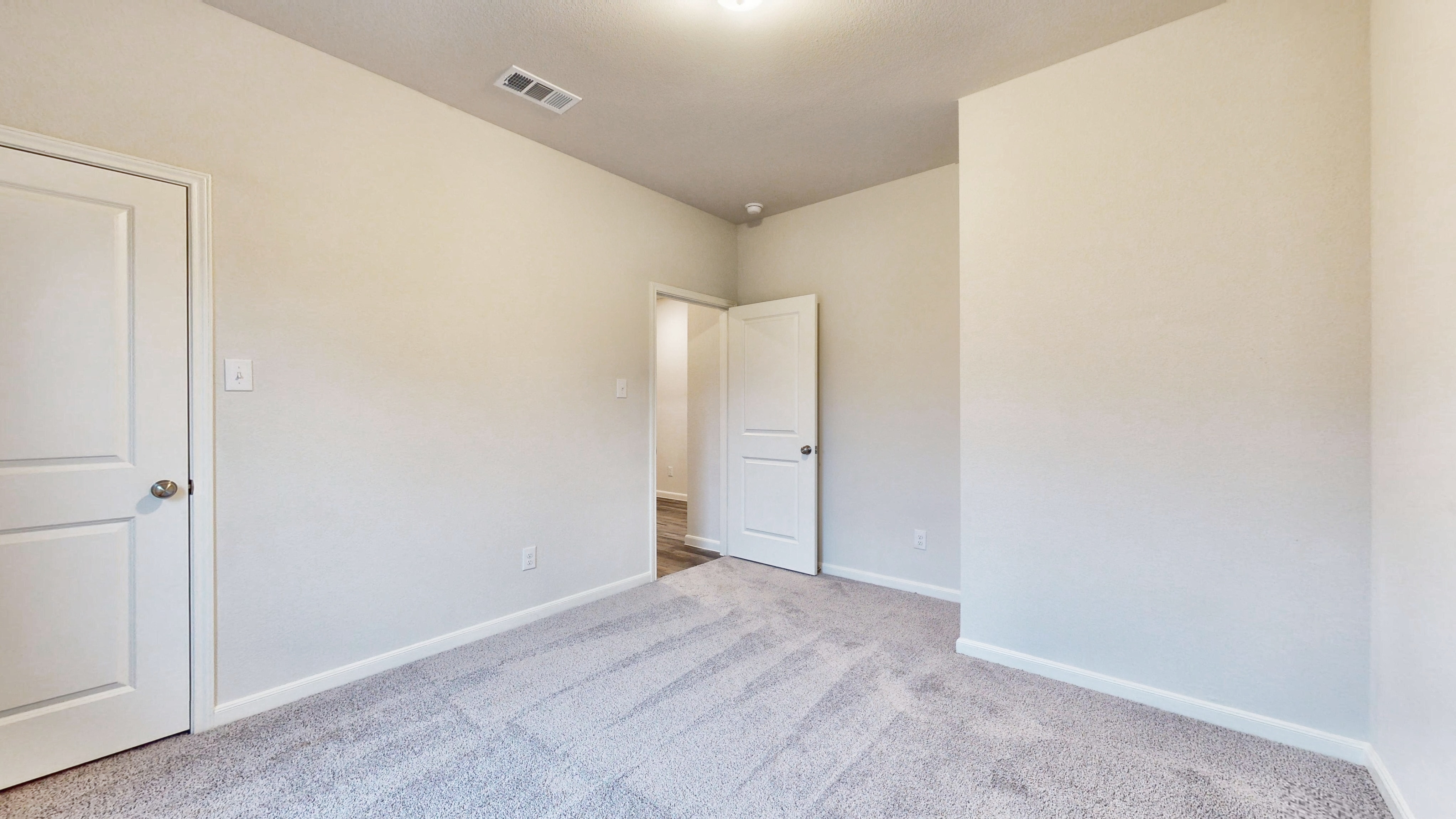 A hallway with white doors.