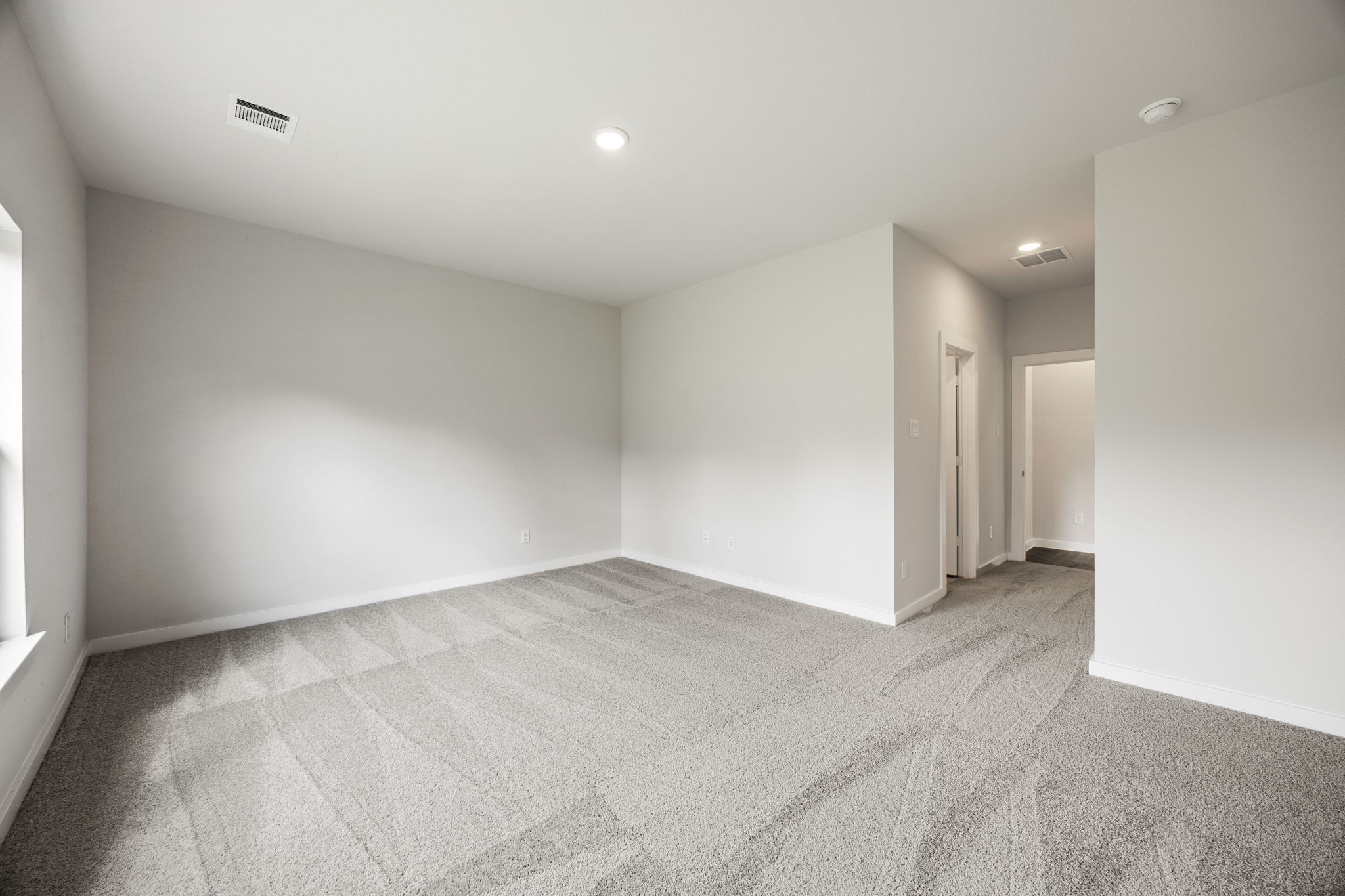 A hallway with white walls.