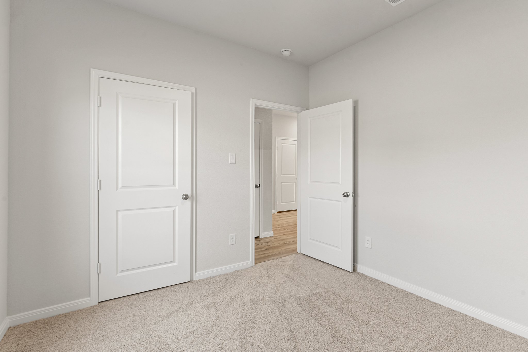 A hallway with white doors.