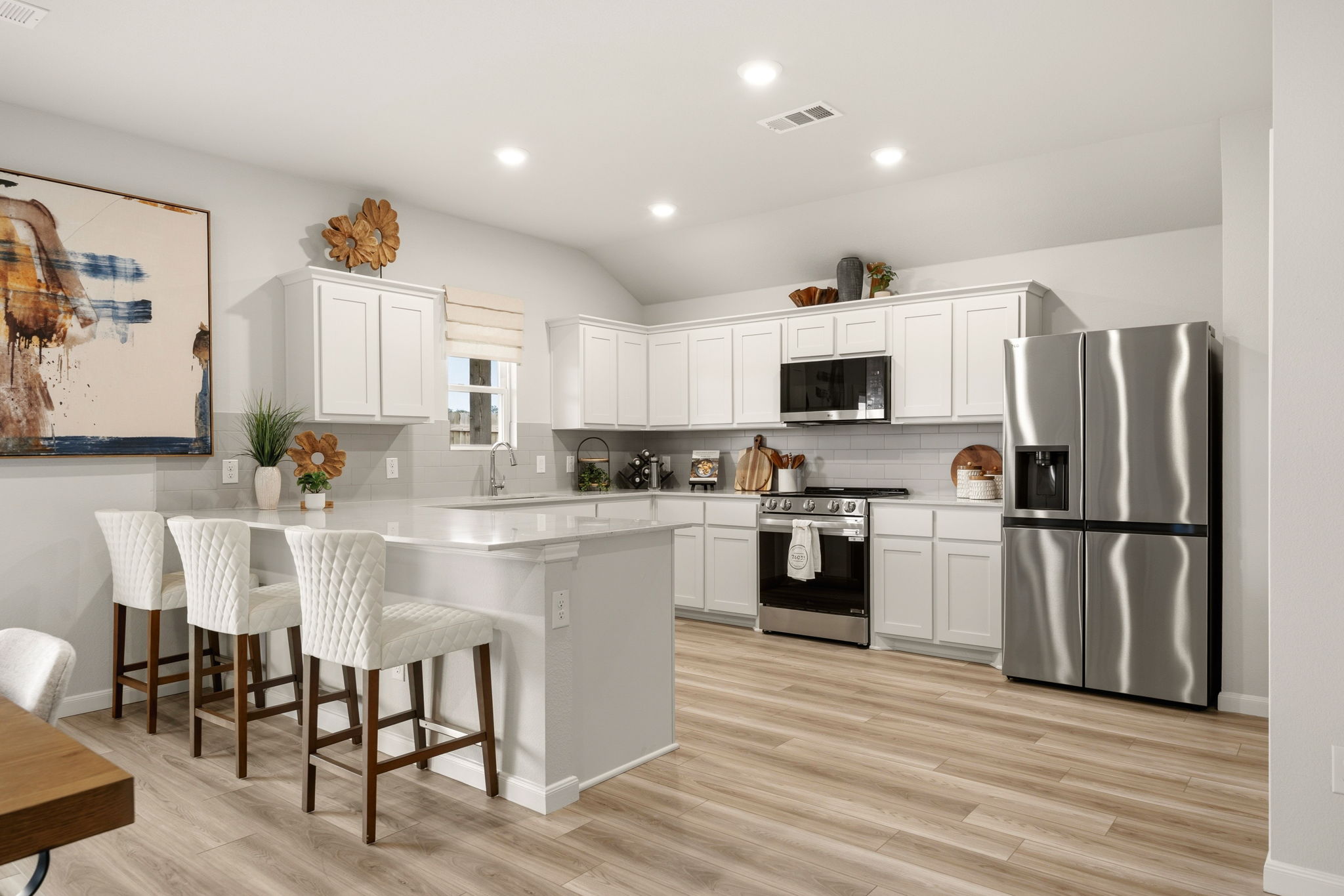 A kitchen with white cabinets.