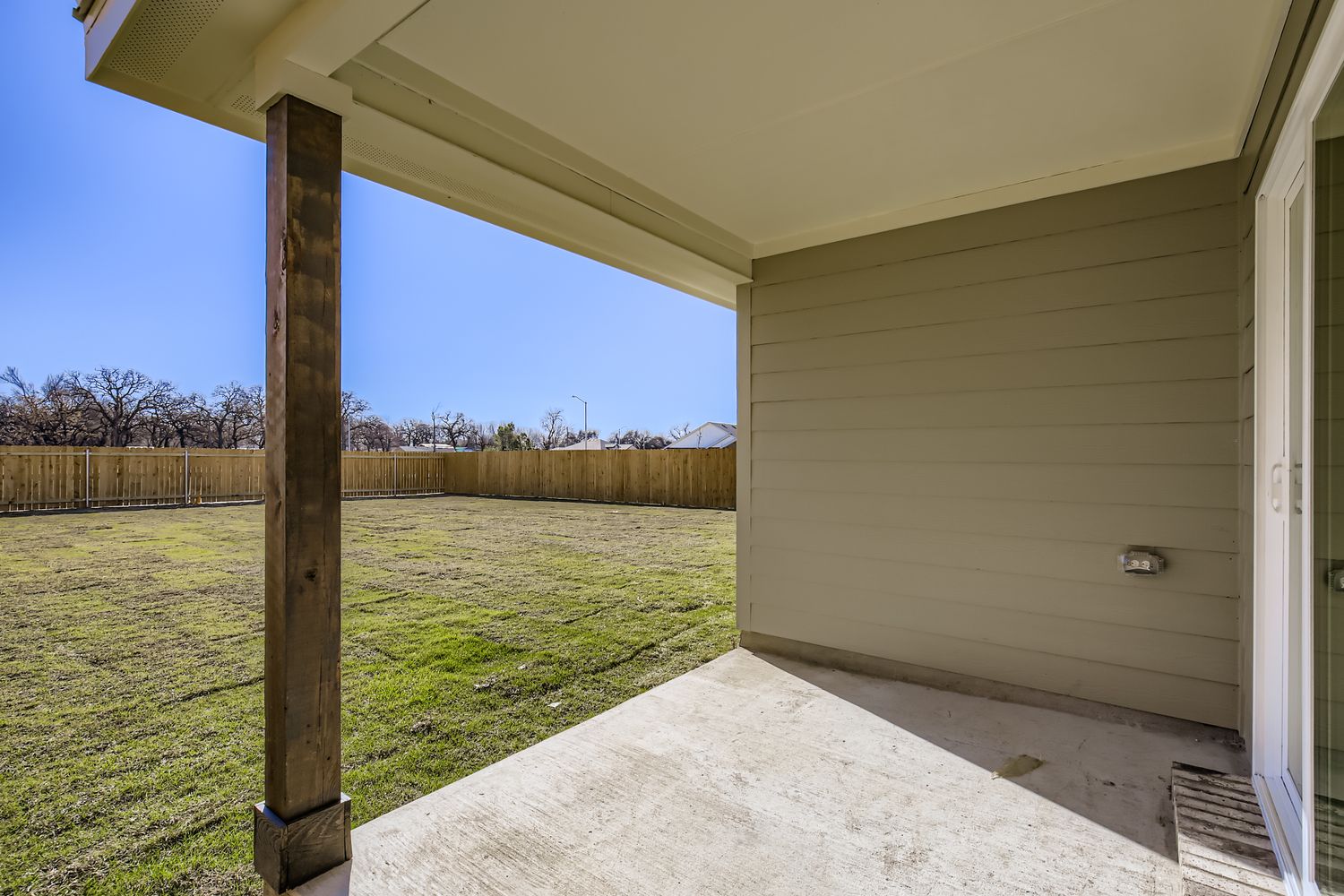 A house with a fence and grass.
