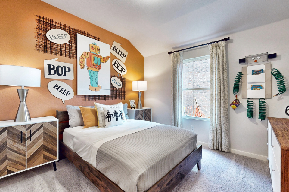 A bedroom with a bed and lamps.