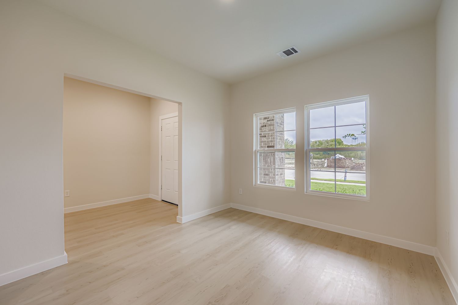 A room with a wood floor and a window.