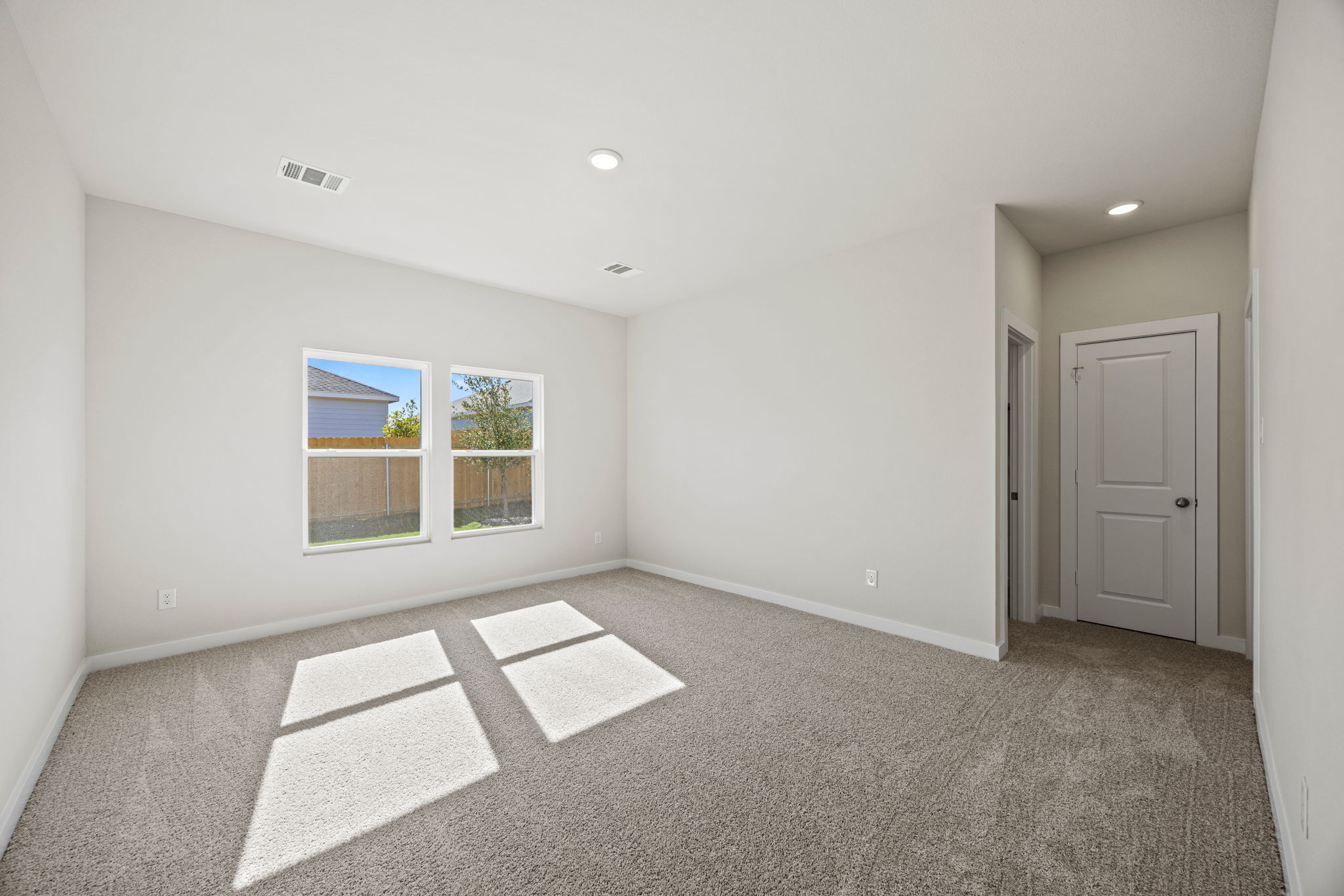 A room with a rug and a door.