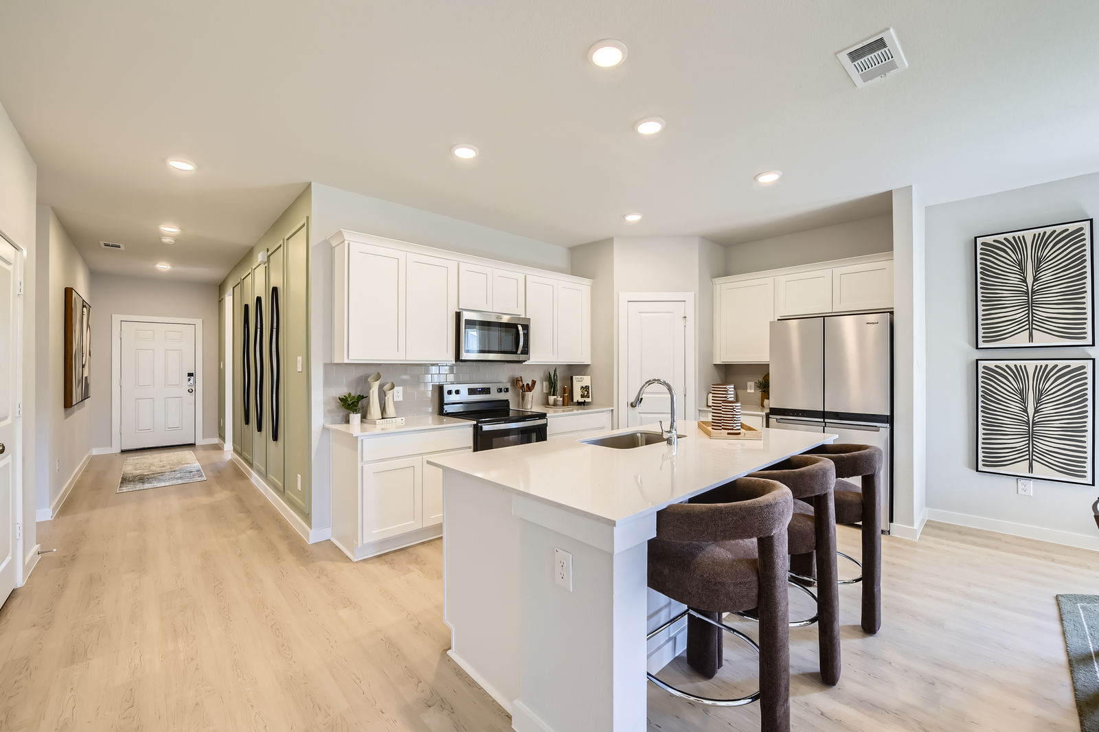 A kitchen with white cabinets.