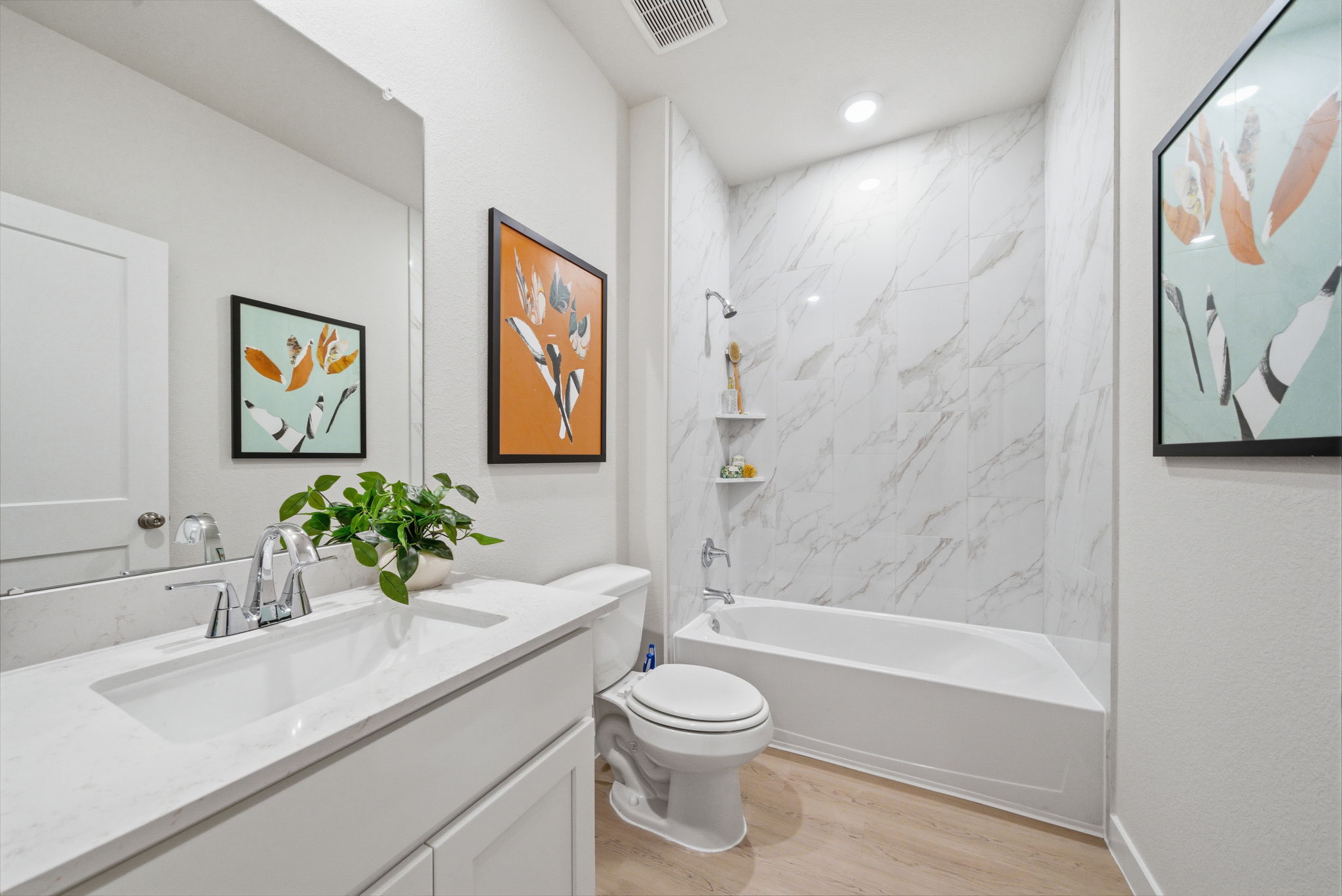 A bathroom with a tub toilet and sink.