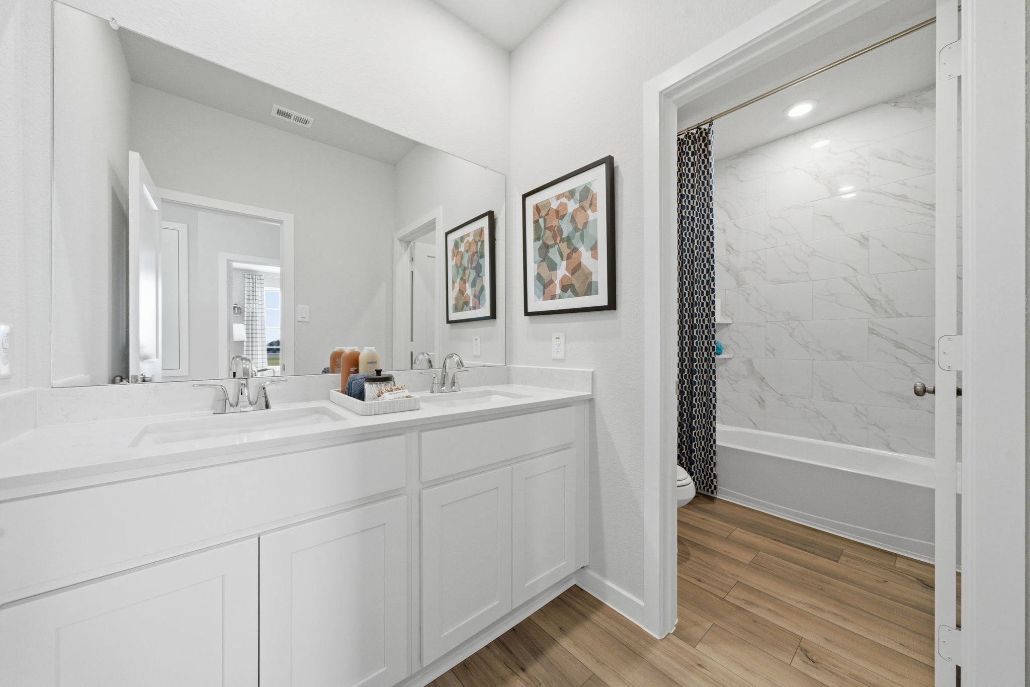 A bathroom with a shower and sink.