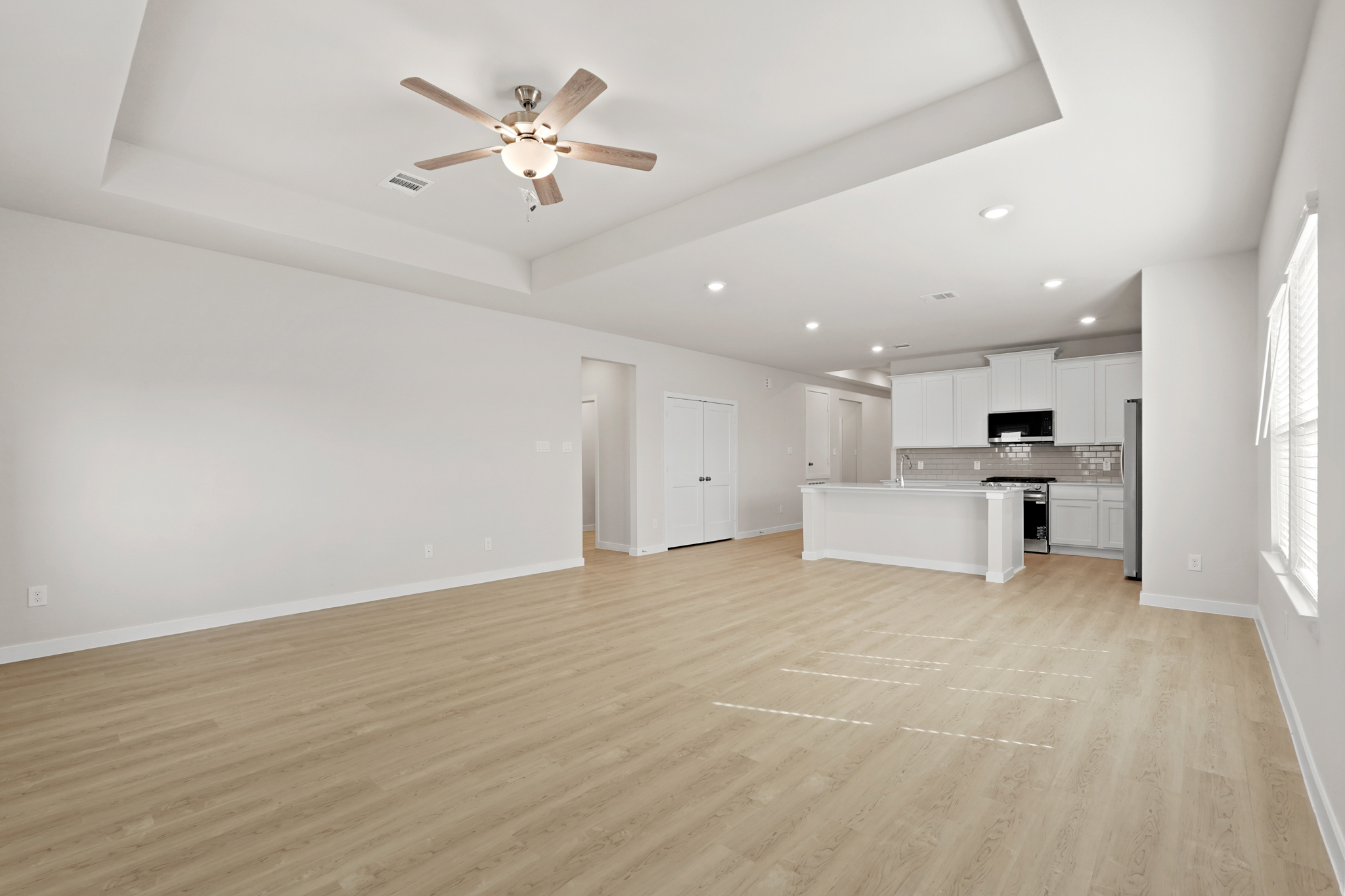 A large kitchen with white walls.