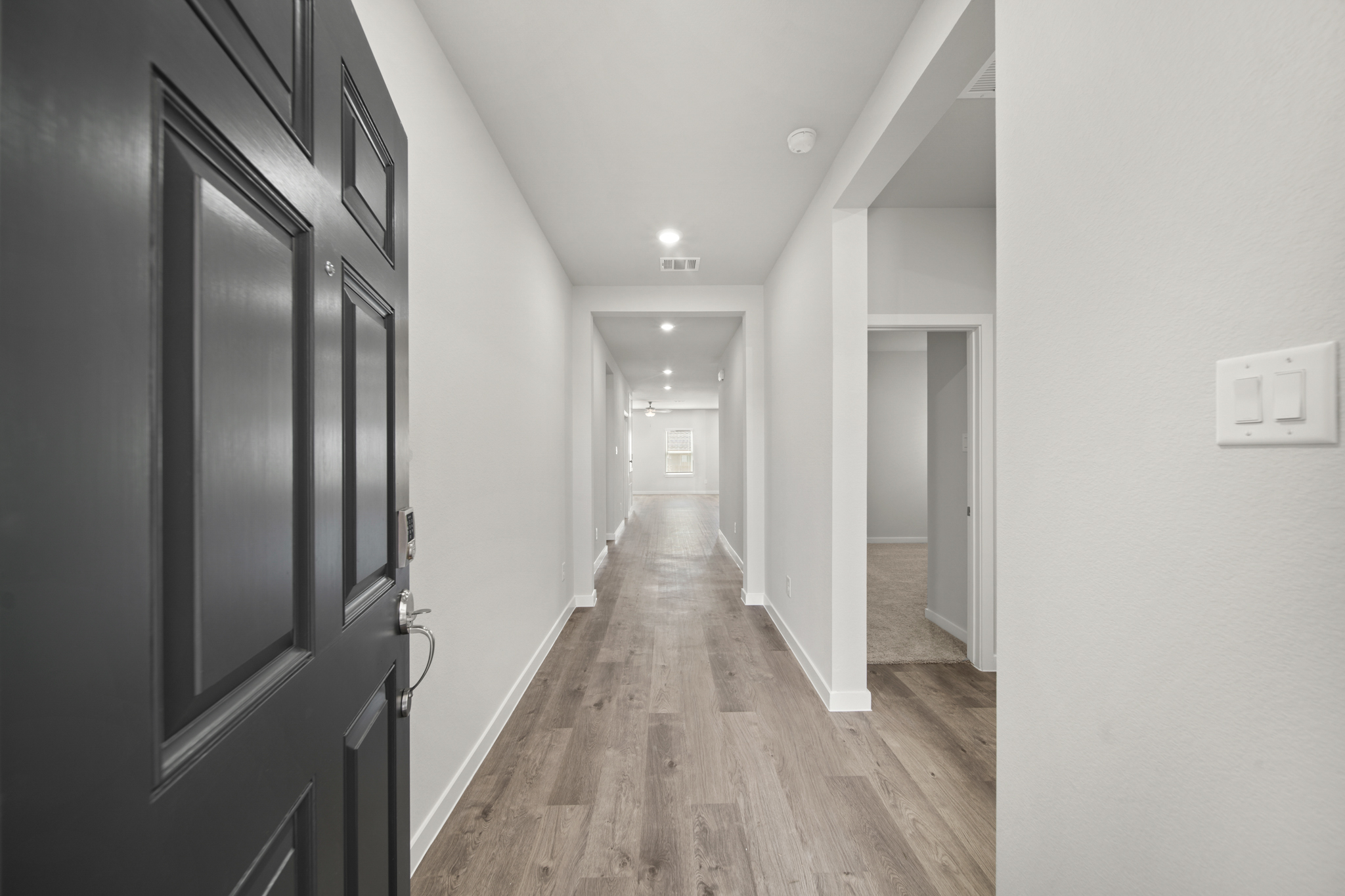 A hallway with black doors.