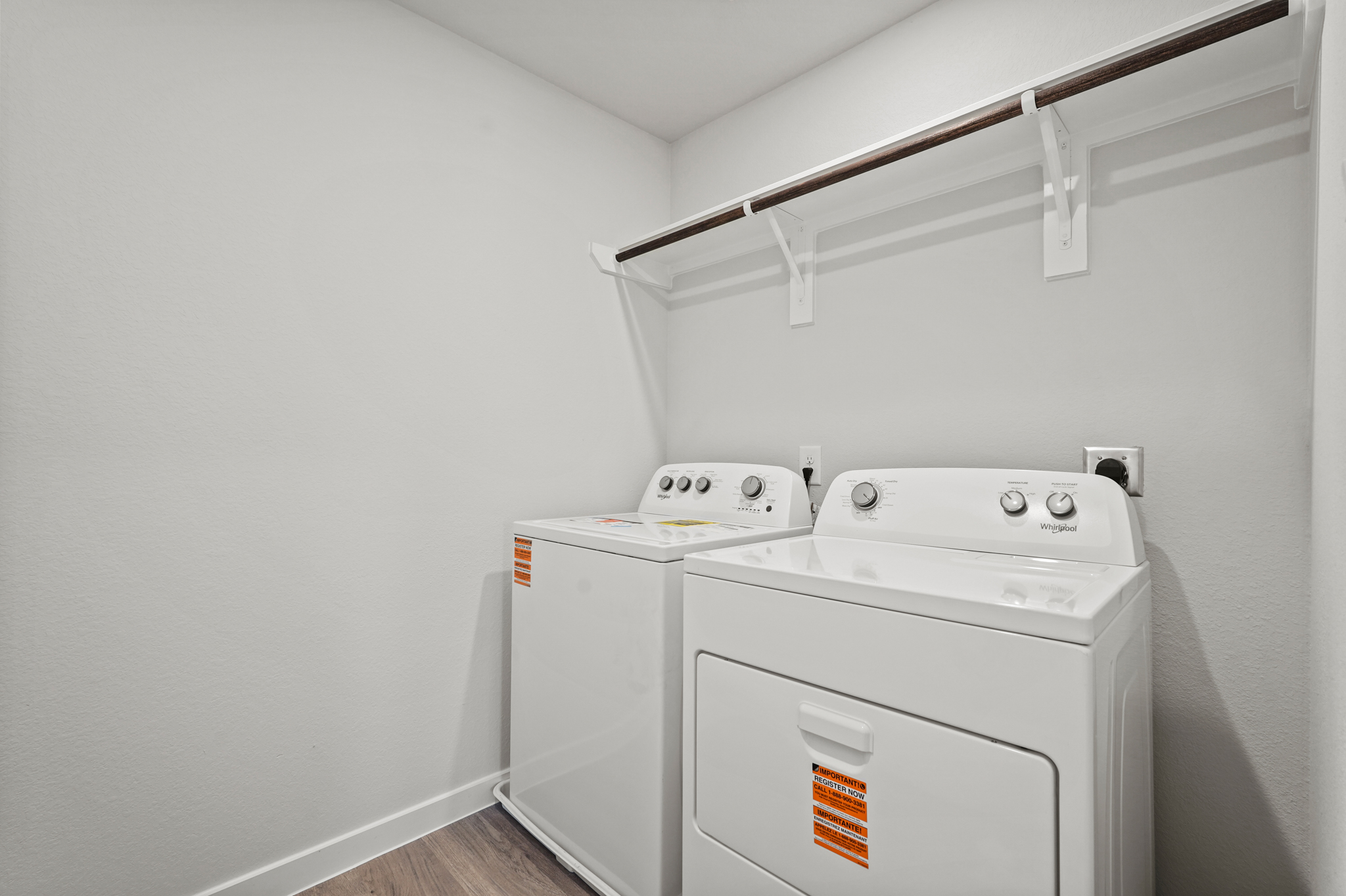 A white laundry room with a white washer and dryer.