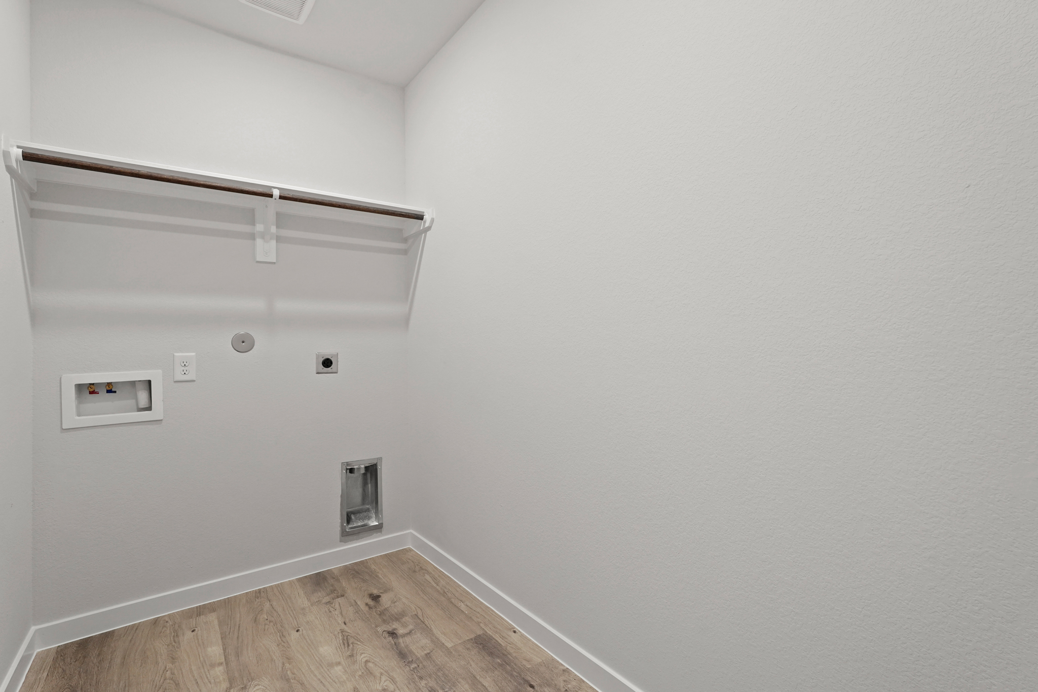 A white wall with a light fixture.