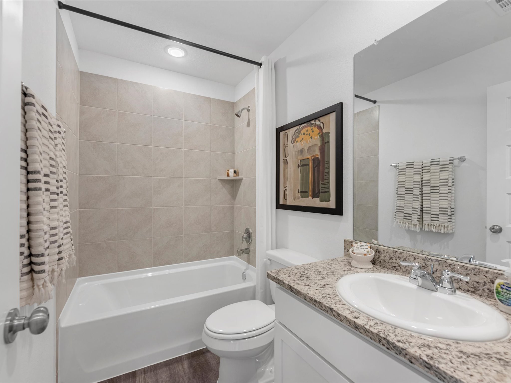 A bathroom with a sink toilet and bathtub.
