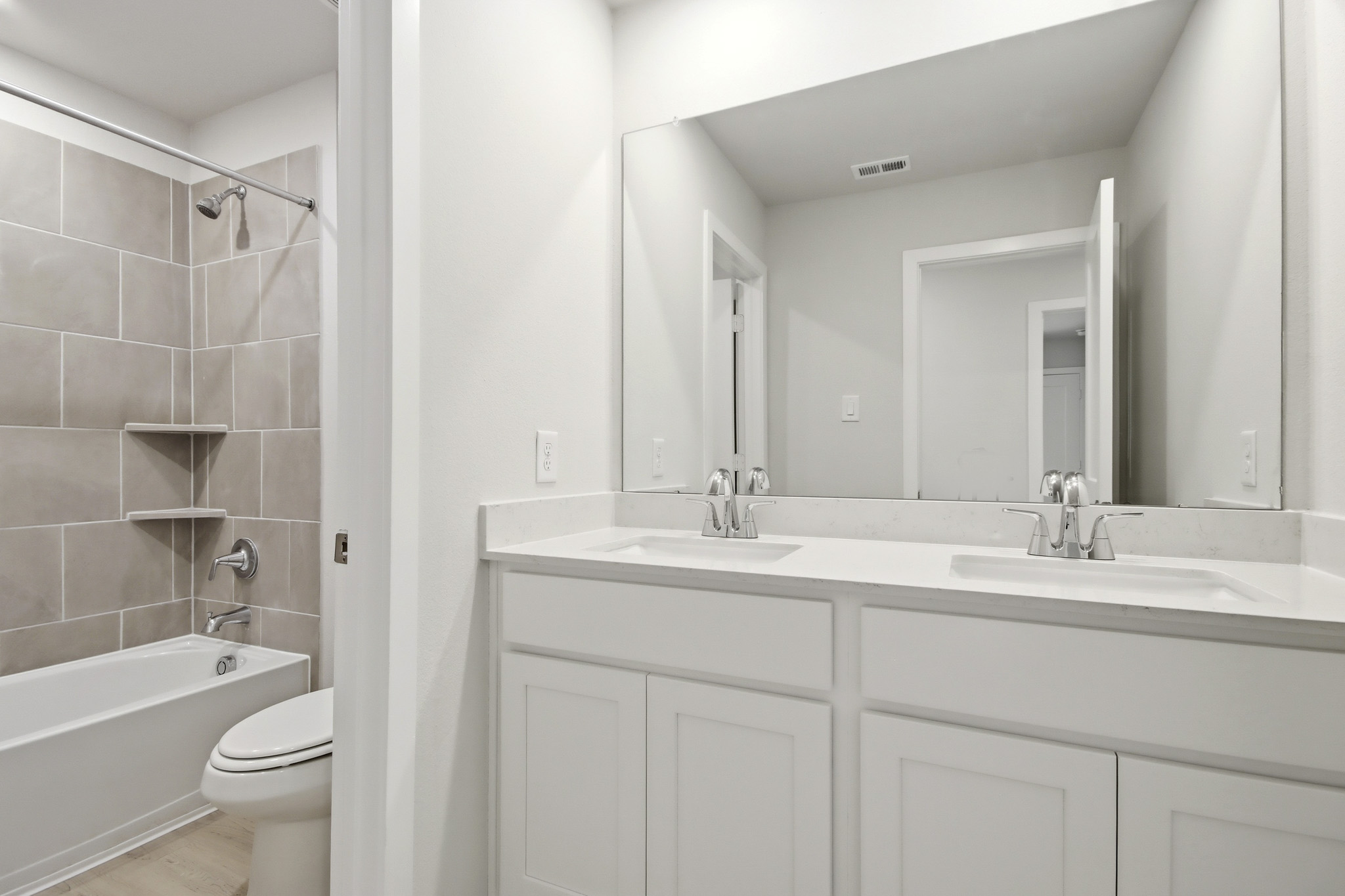 A bathroom with a tub sink and toilet.