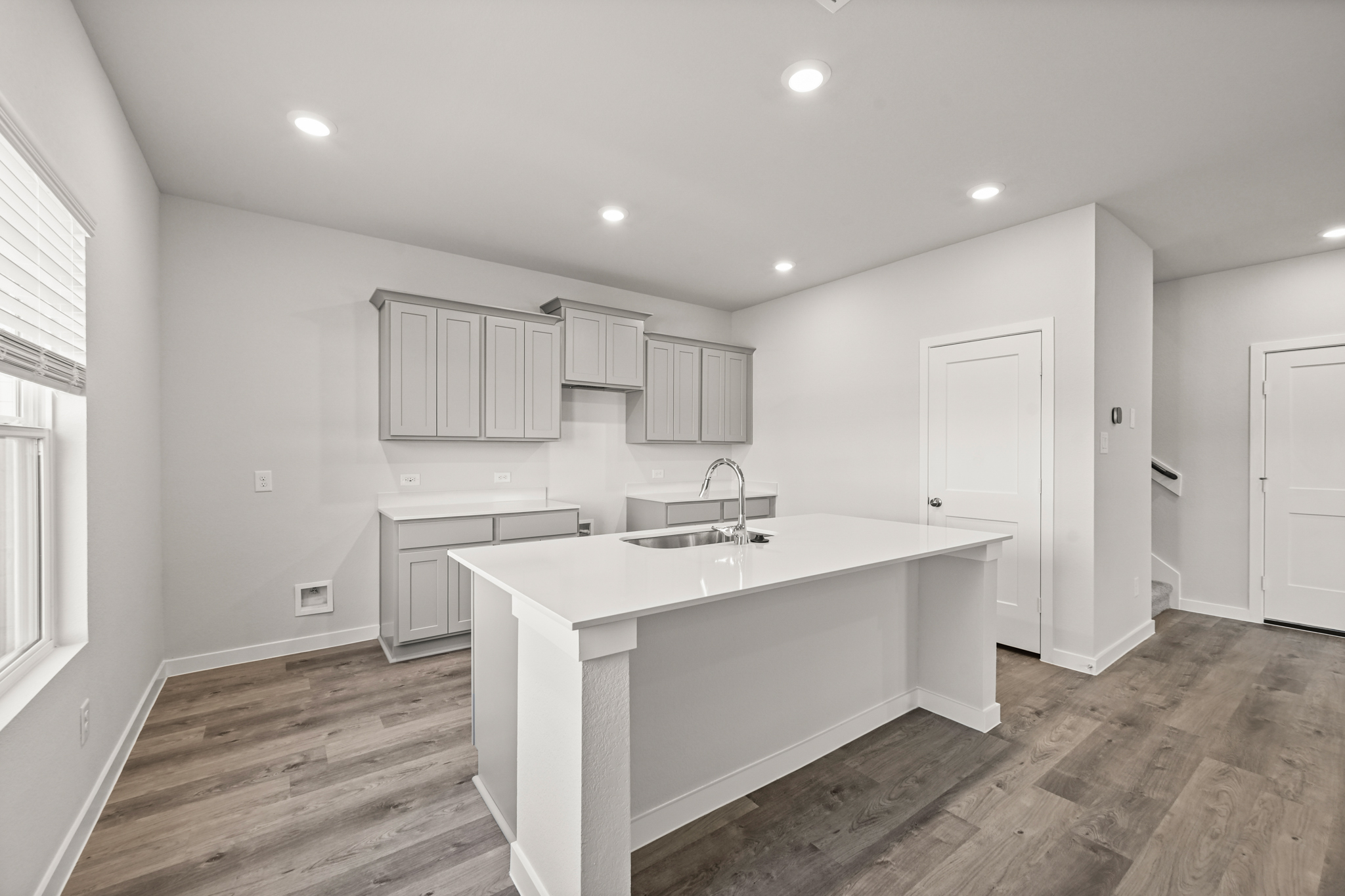 A kitchen with white cabinets.