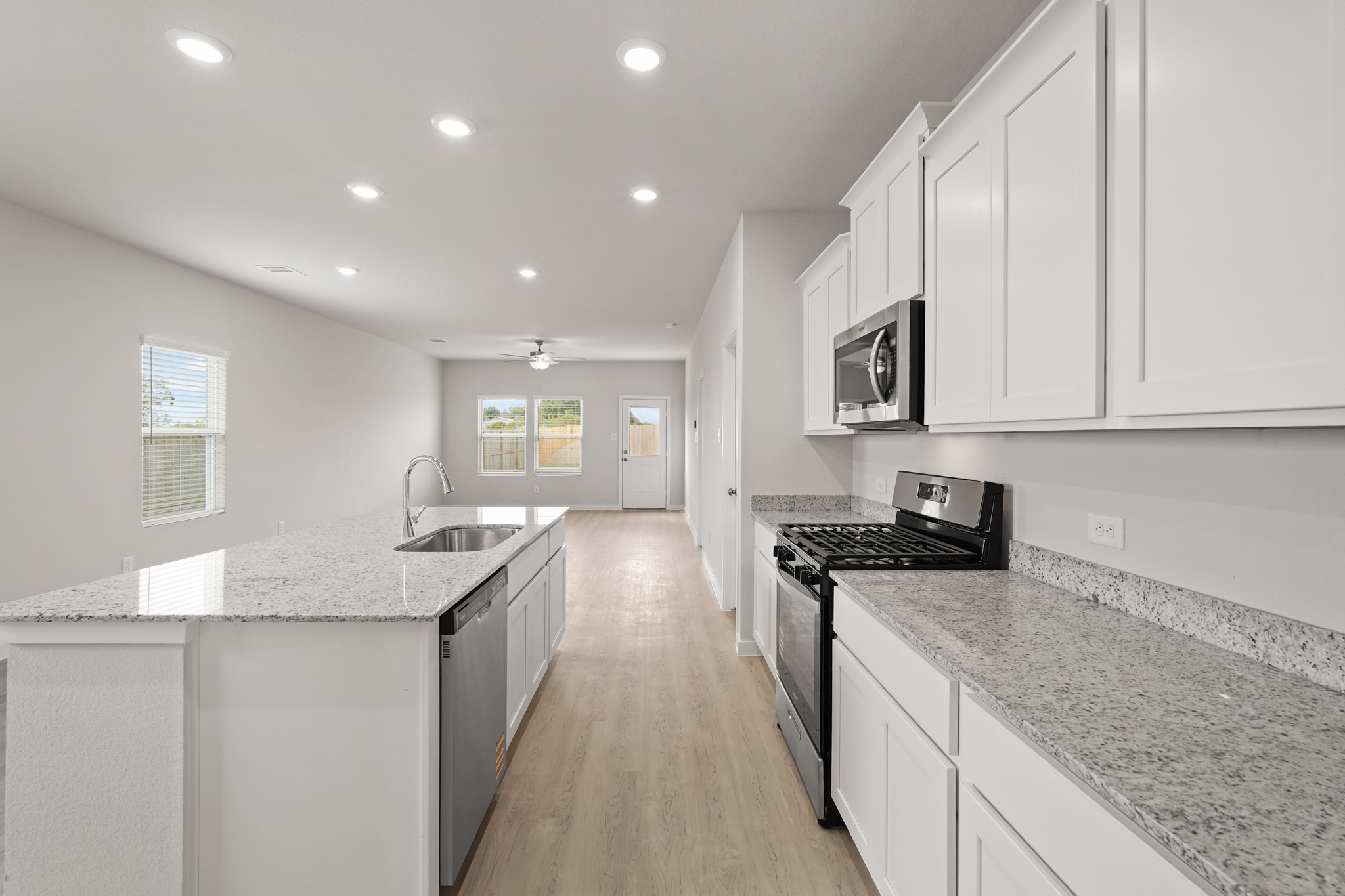 A kitchen with white cabinets.