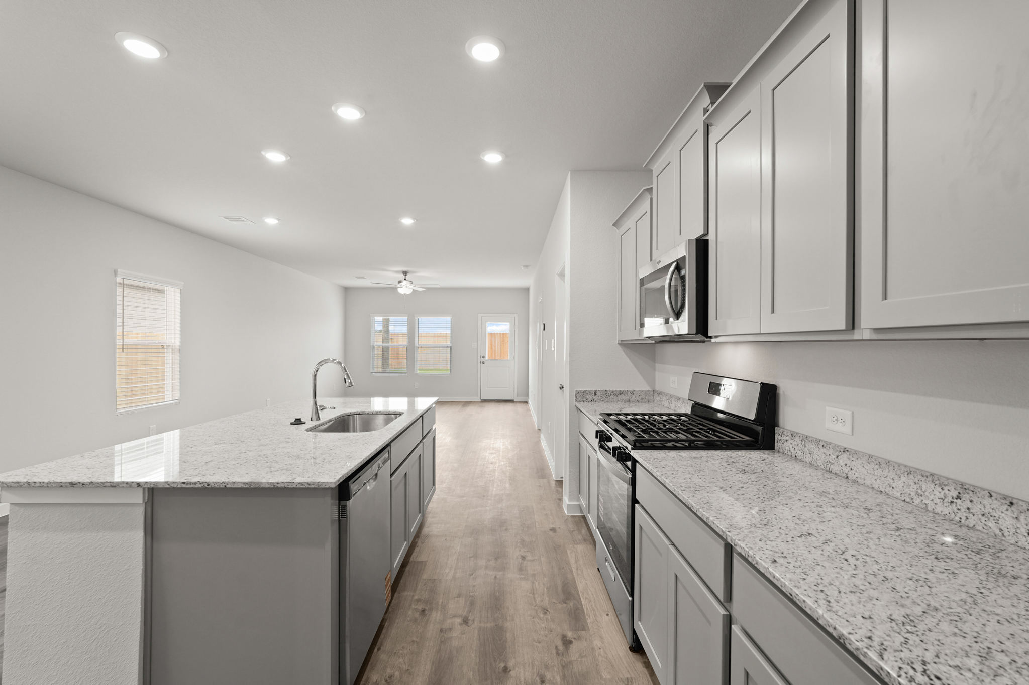 A kitchen with marble counters.