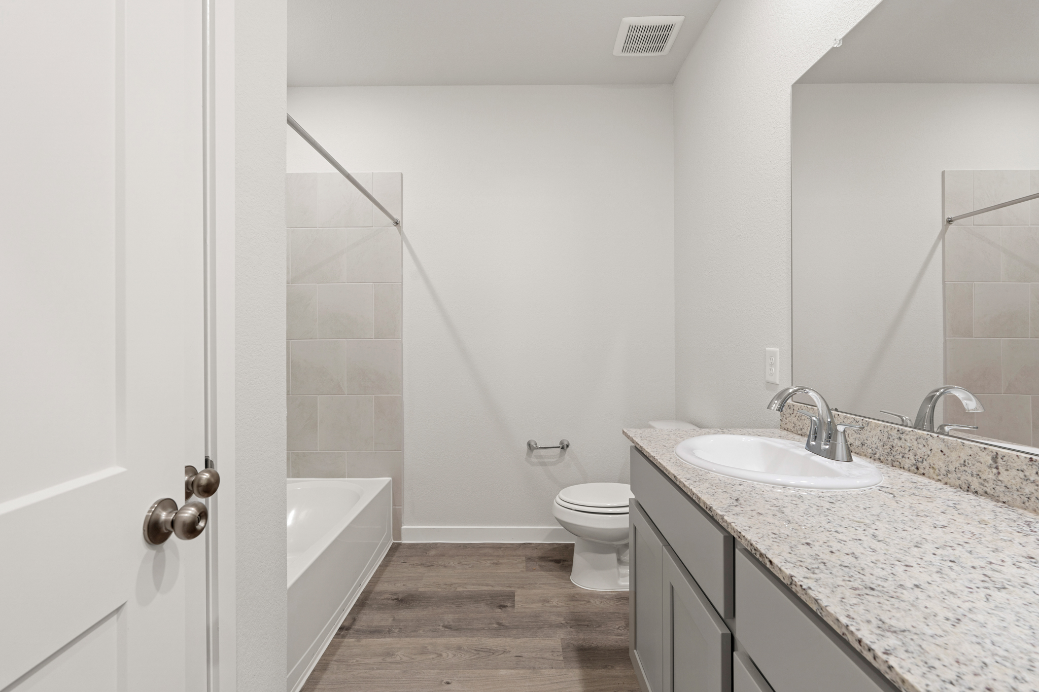 A bathroom with a marble countertop.