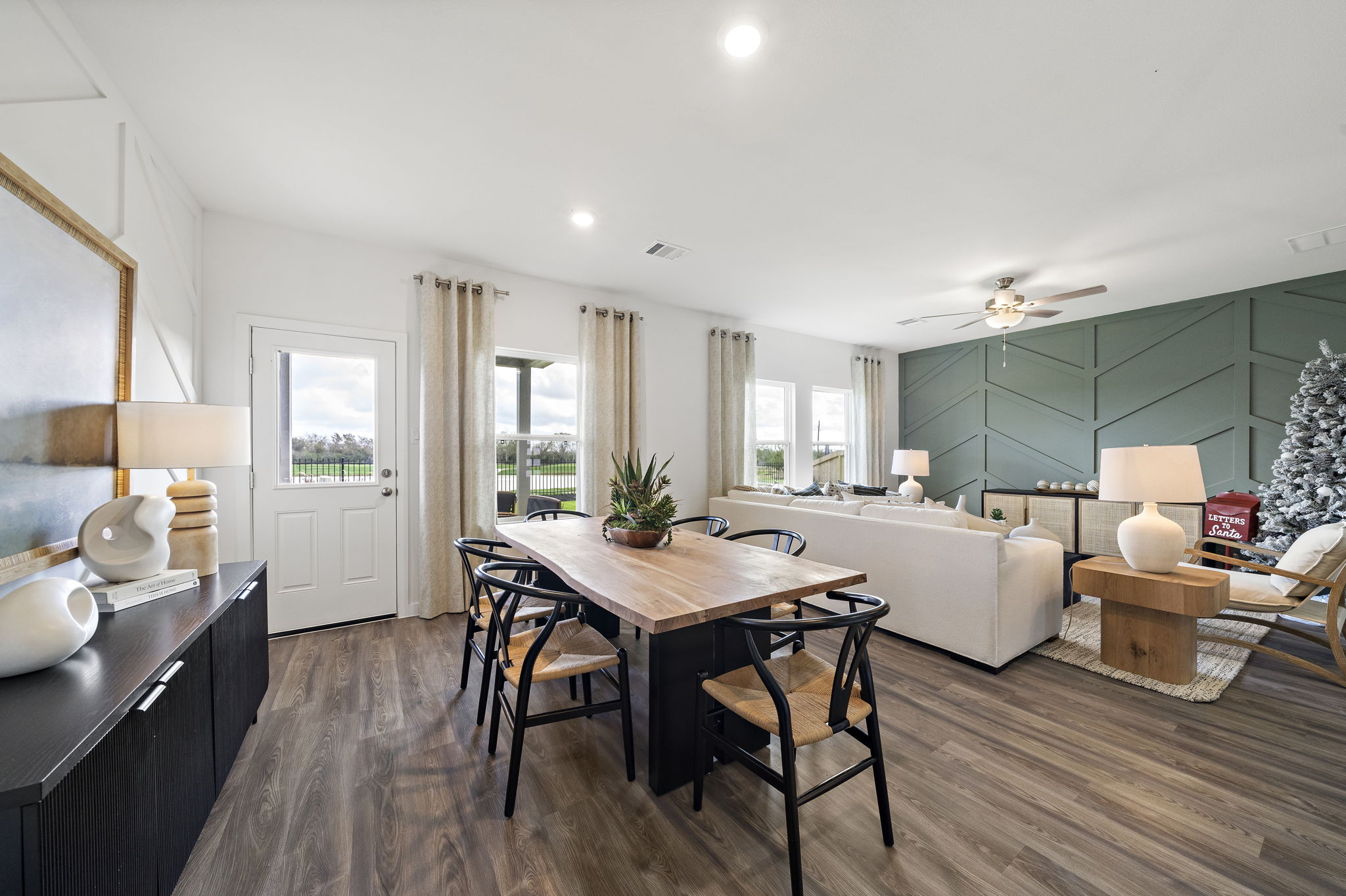 A large living room with a large table and chairs.