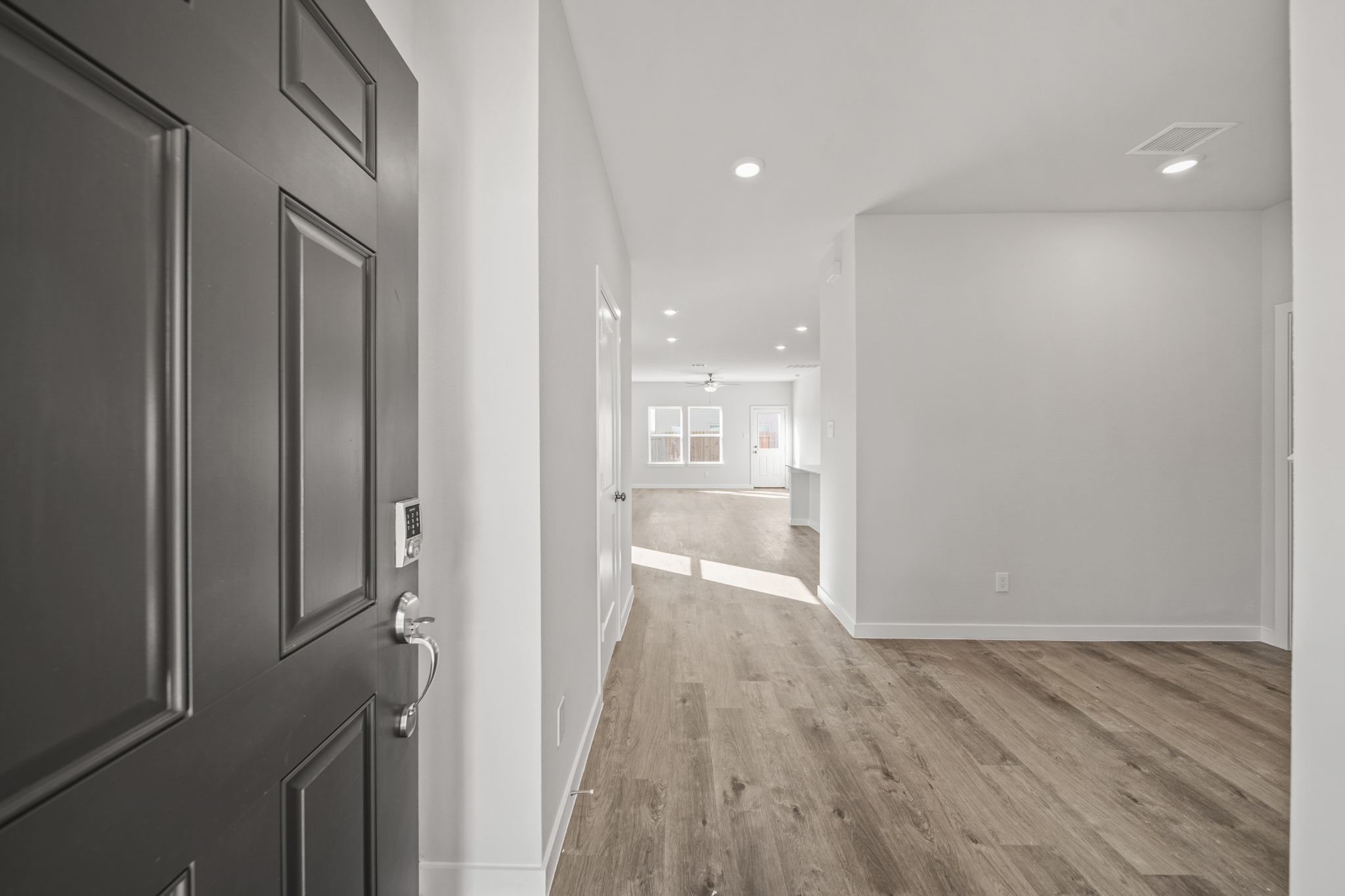 A hallway with black doors.