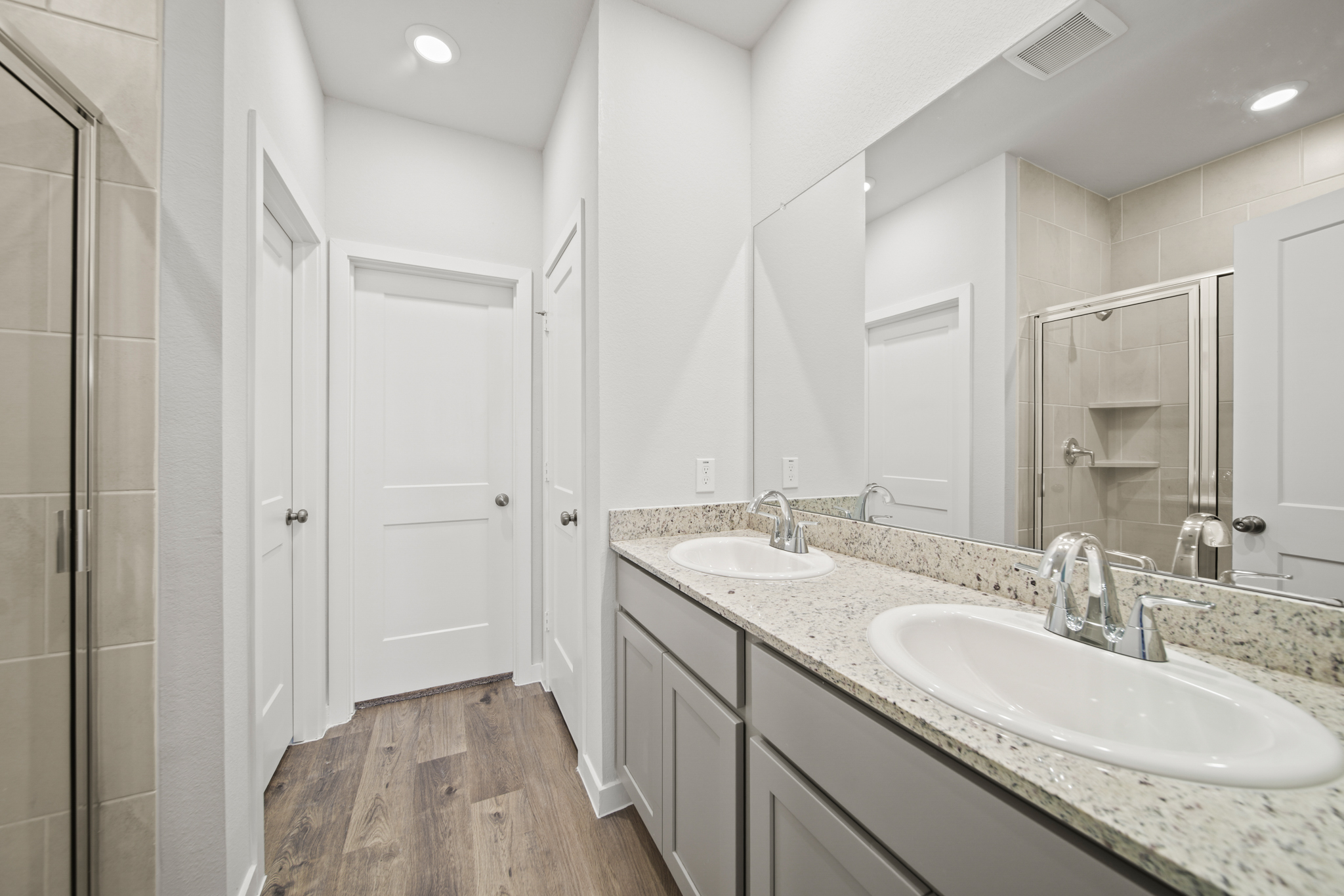 A bathroom with a large mirror.