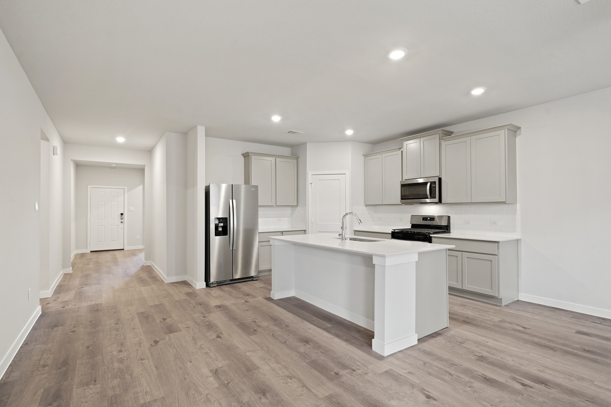 A kitchen with white cabinets.