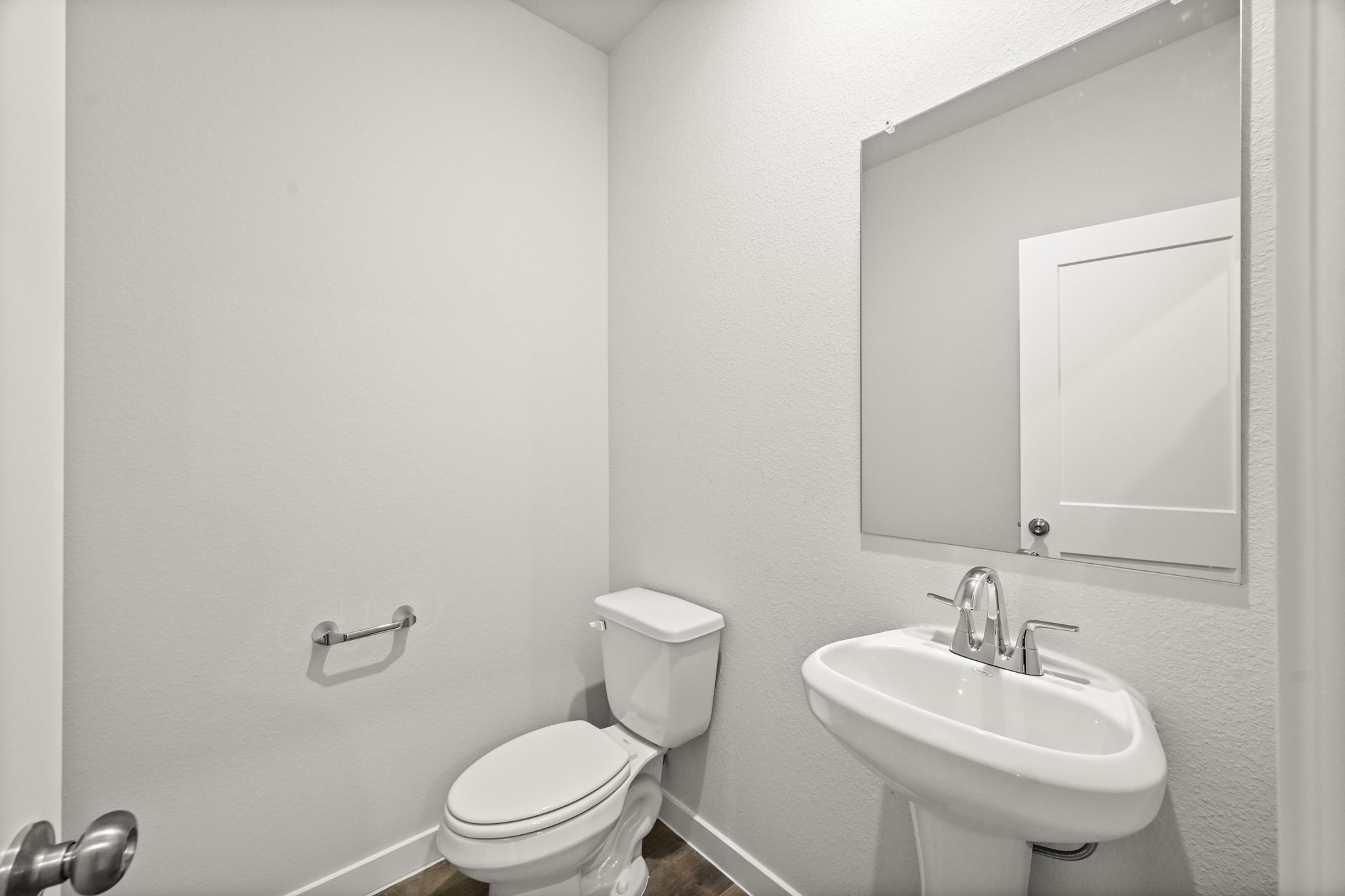 A bathroom with a toilet and sink.
