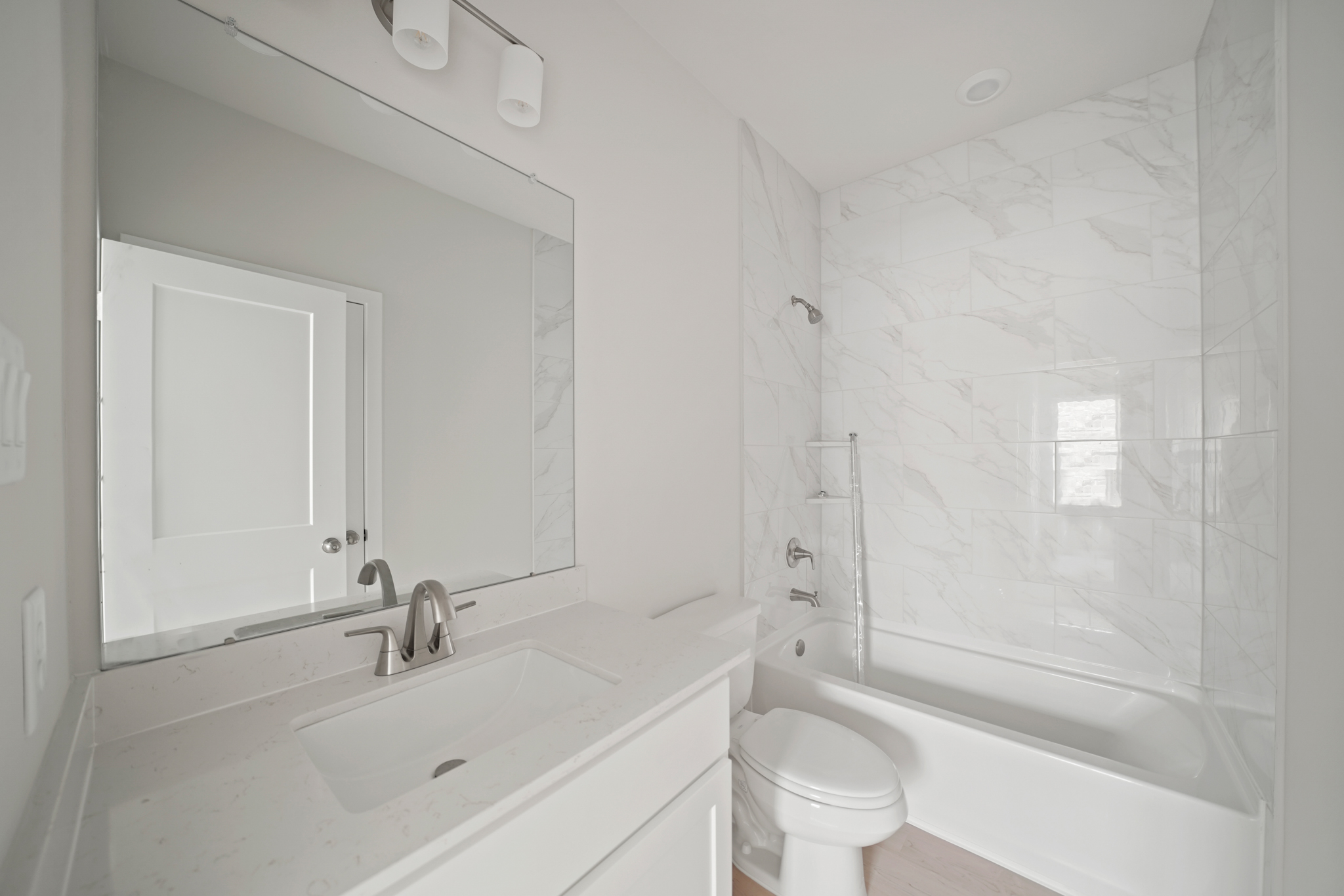 A bathroom with a tub toilet and sink.